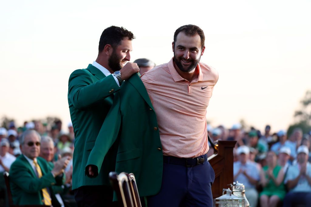 AUGUSTA, GEORGIA - APRIL 14: Scottie Scheffler of the United States is awarded the Green Jacket by 2023 Masters champion Jon Rahm of Spain during the Green Jacket Ceremony after Scheffler won the 2024 Masters Tournament at Augusta National Golf Club on April 14, 2024 in Augusta, Georgia. (Photo by Maddie Meyer/Getty Images)
