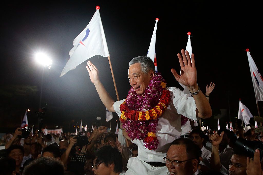 SINGAPORE - SEPTEMBER 11: Prime Minister and People's Action Party (PAP) Secretary General, Lee Hsien Loong celebrates after winning his seat for Ang Mo Kio Group Representation Constituency (GRC) on September 11, 2015 in Singapore. The 2015 general election sees all 89 parliamentary seats being contested for the first time since independence in 1965. This is also the first election in Singapore's history without founding Prime Minister, Lee Kuan Yew, who passed away in March this year. (Photo by Suhaimi