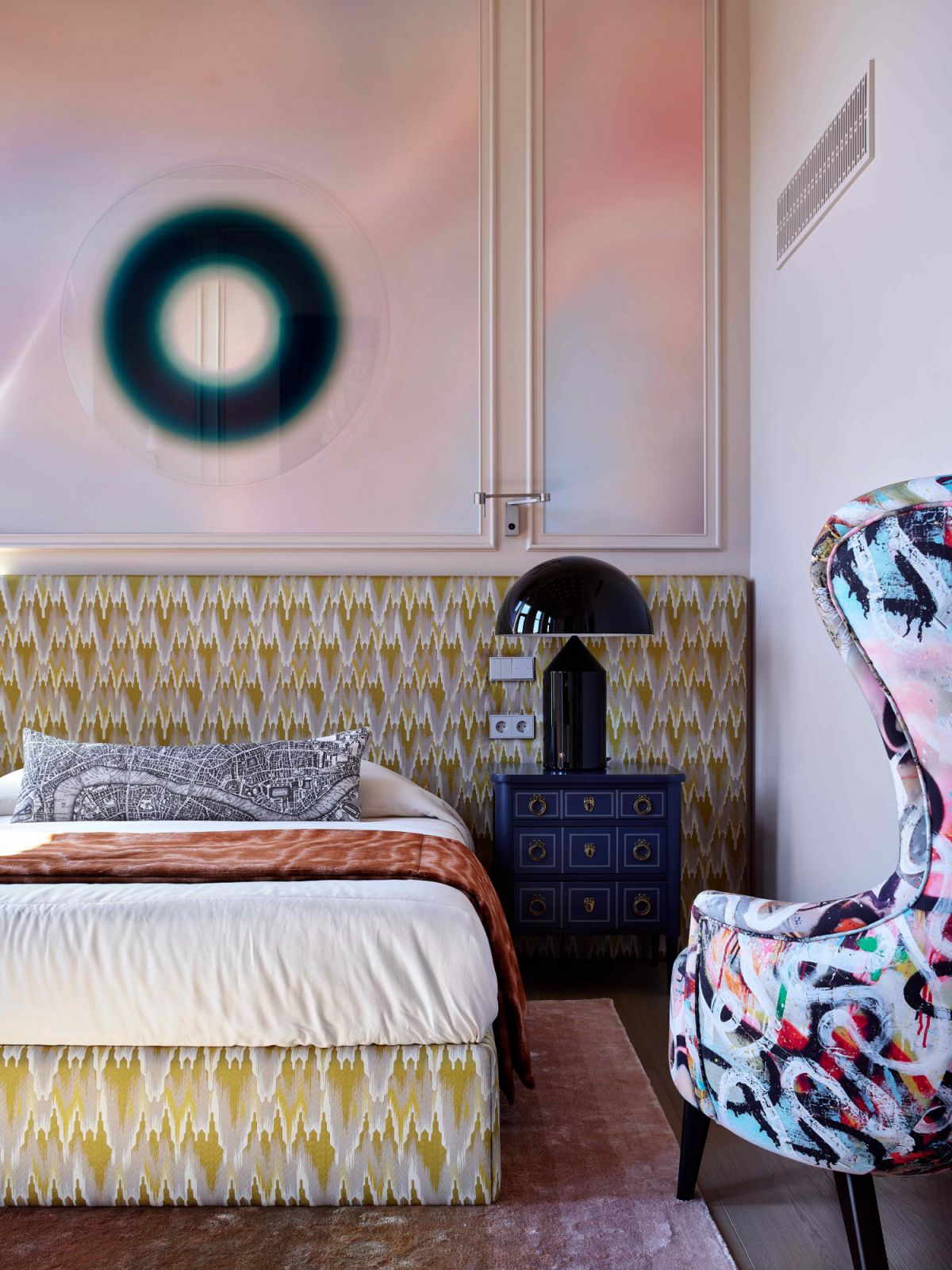 Pearly pink walls contrast the contemporary furniture with bold patterns