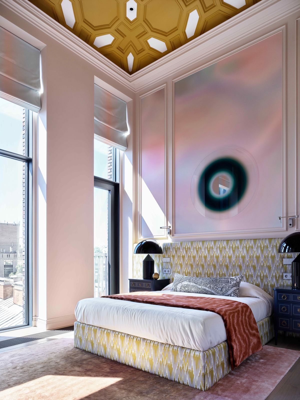 The daughter's bedroom is pink-hued with a mustard coffered ceiling