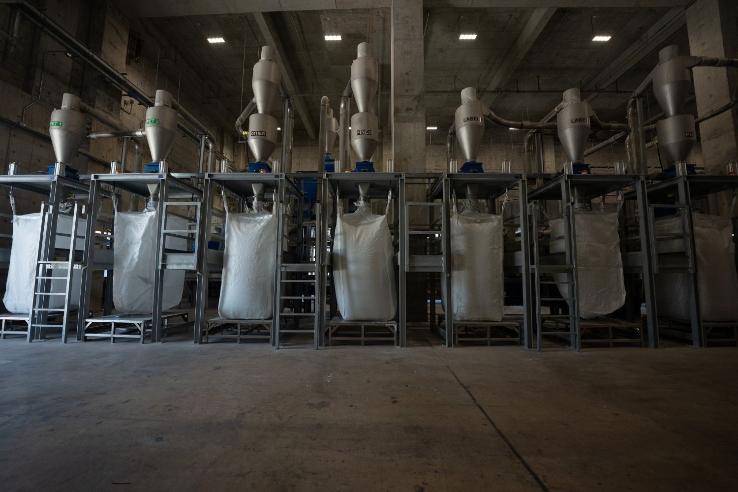 Plastic bottles are processed into flakes which are collected in these vats depending on the type of plastic (Photo: courtesy of New Life Plastics)