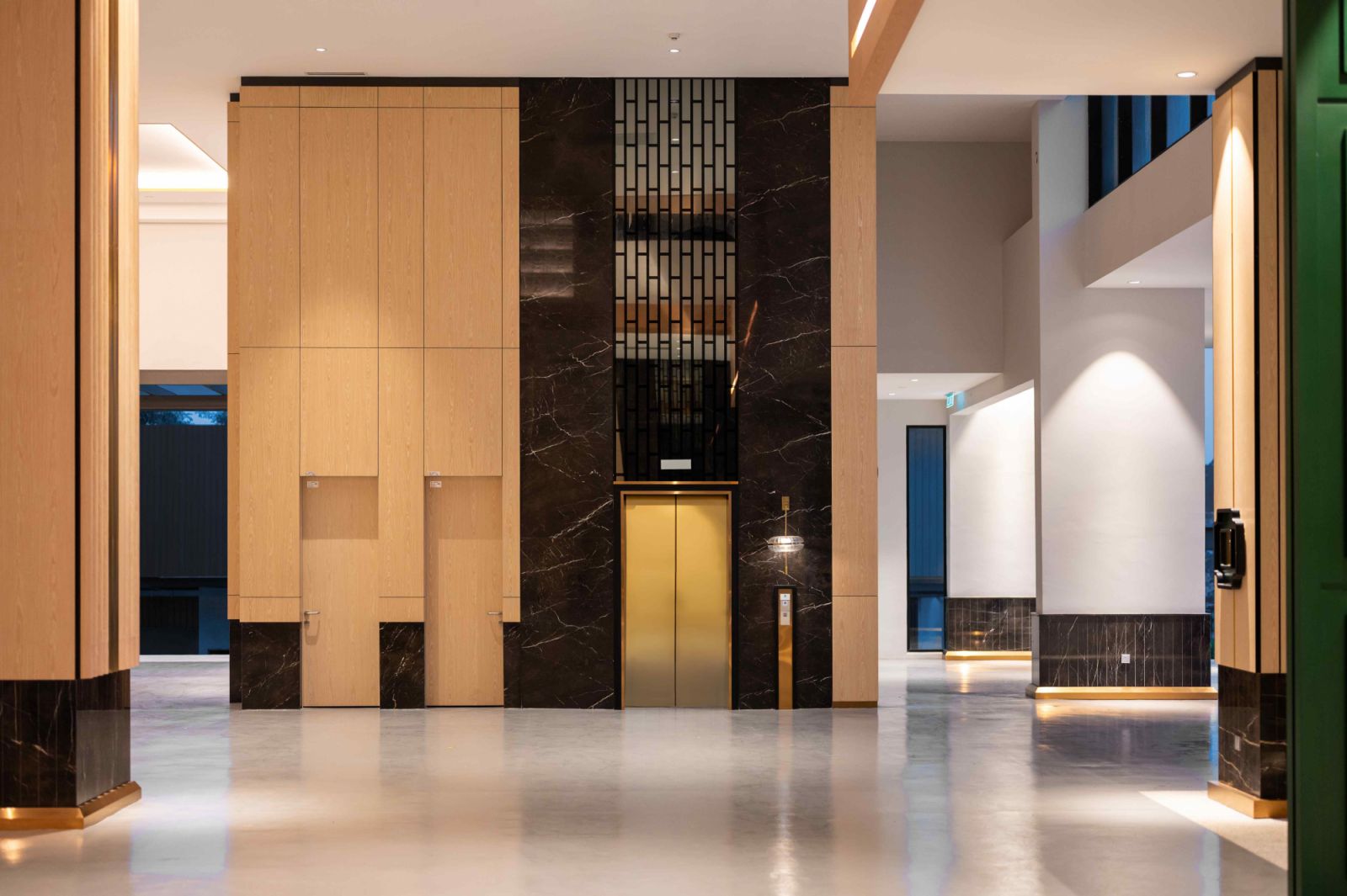Polished dark marble work against light-coloured wood