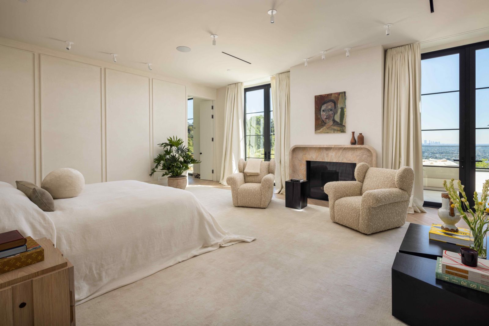 The main primary suite fitted with a Calacatta Breccia fireplace