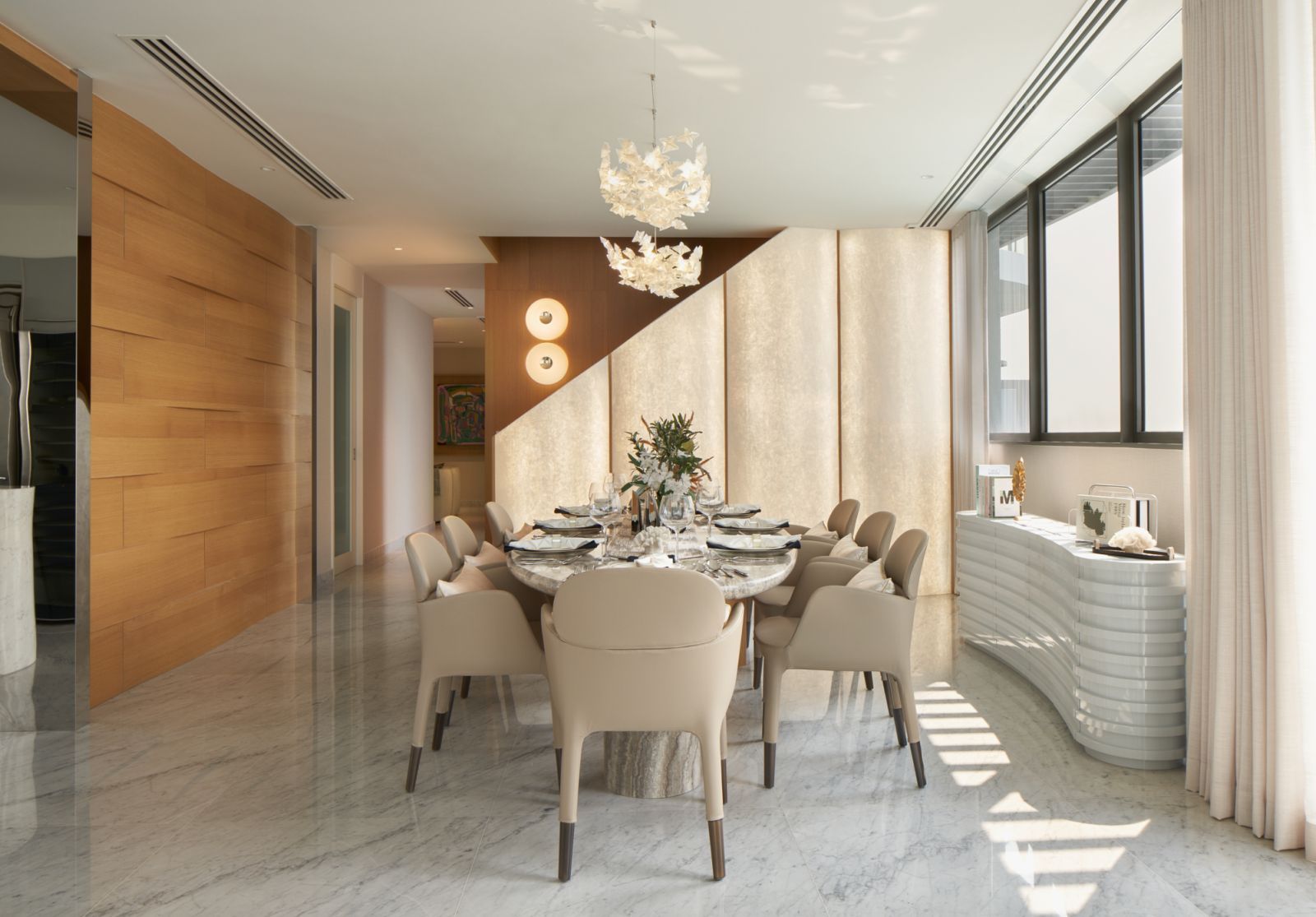 Illuminated wall panels create a striking backdrop in the elegant dining area