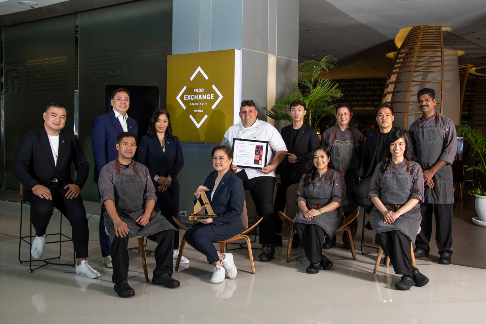 Cluster General Manager Maria Manlulu-Garcia and Hotel Manager Darwin Labayanday with Executive Chef Massi Pauletto and the F&B, Culinary and Banquets Team