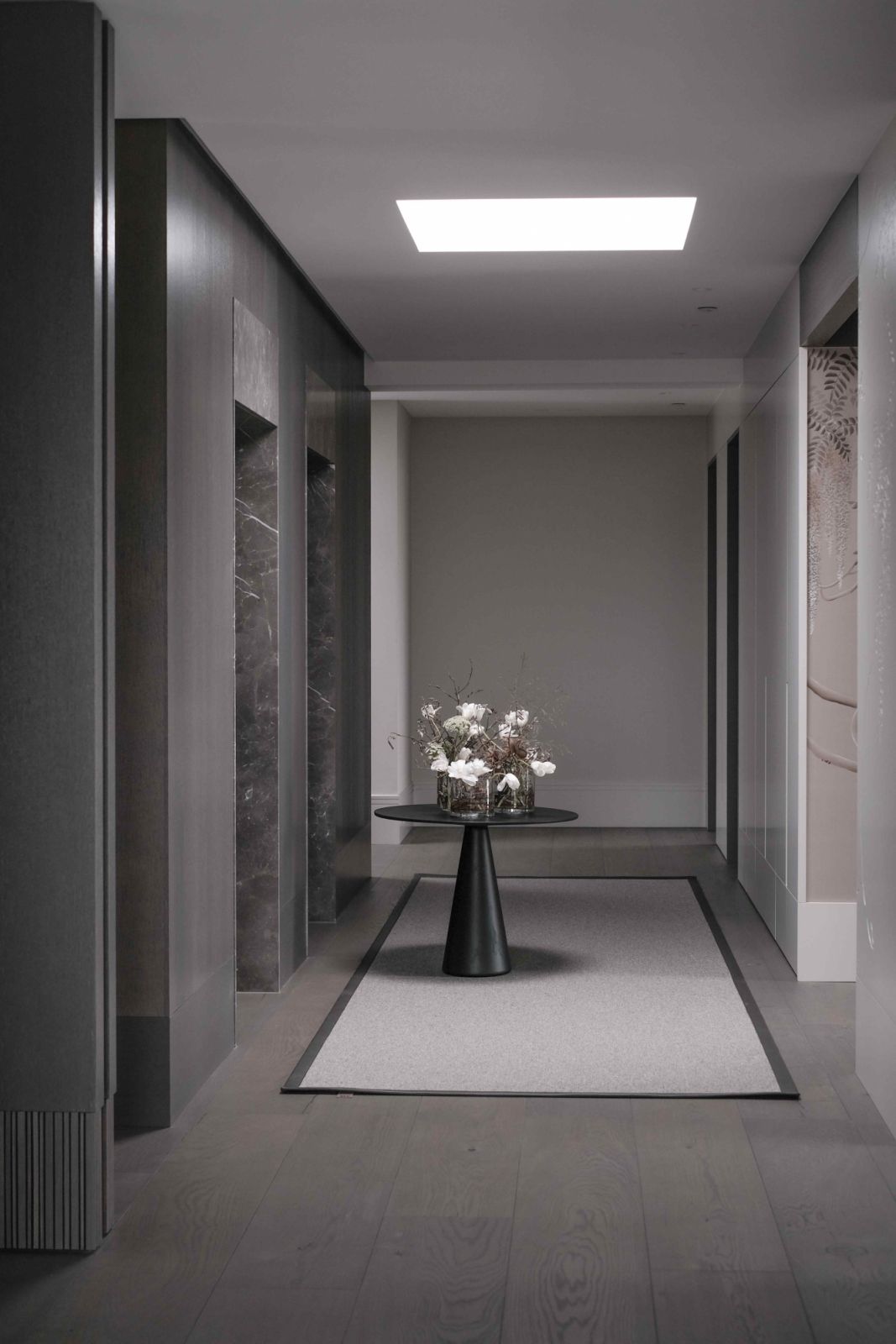 An Ikebana-inspired floral arrangement welcomes at the hallway