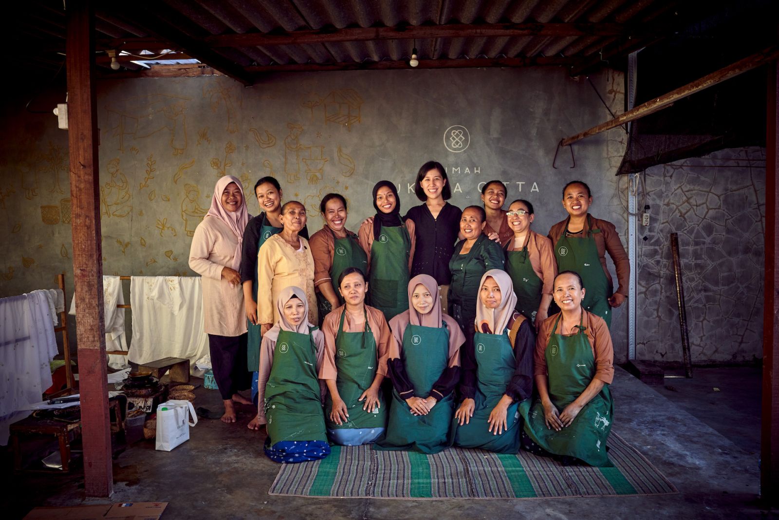 Denica Riadini-Flesch with the batik craftswomen at one of SukkhaCittaâs craft schools Rumah SukkhaCitta. Women are not only taught traditional crafts in SukkhaCitta schools, but the business skills they need to monetize them.