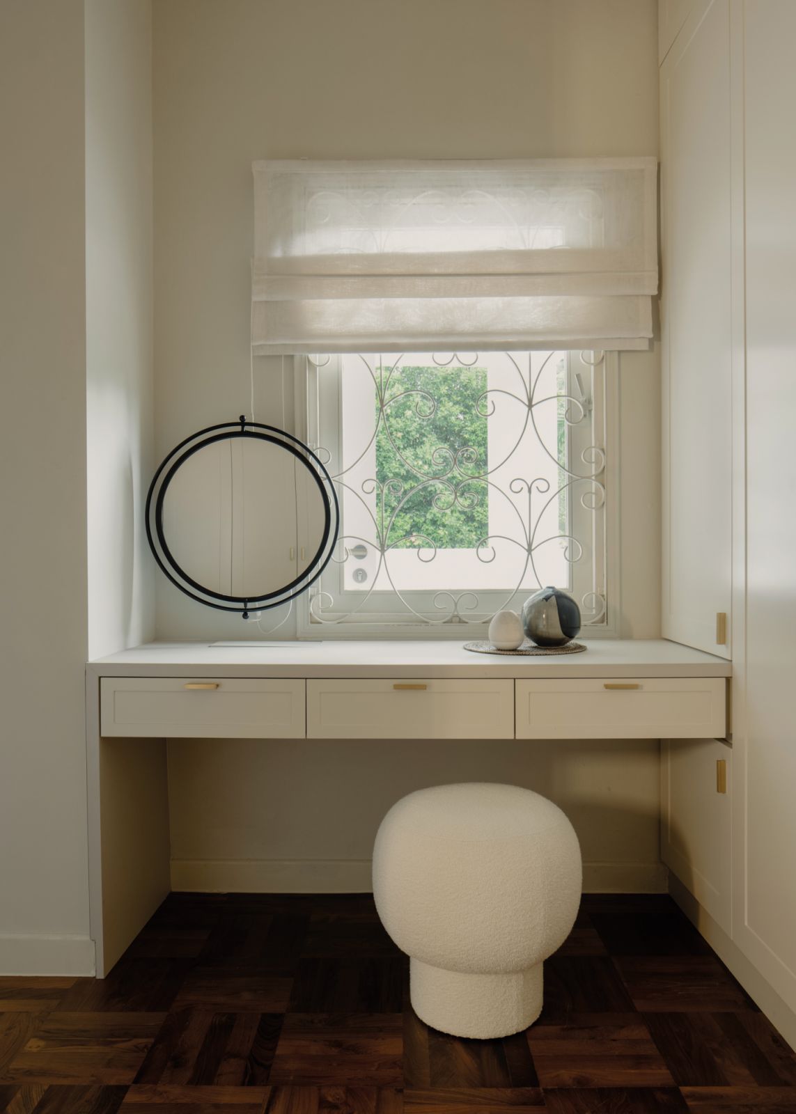 This built-in dressing table keeps things simple, allowing the charm of the original window grilles to stand out
