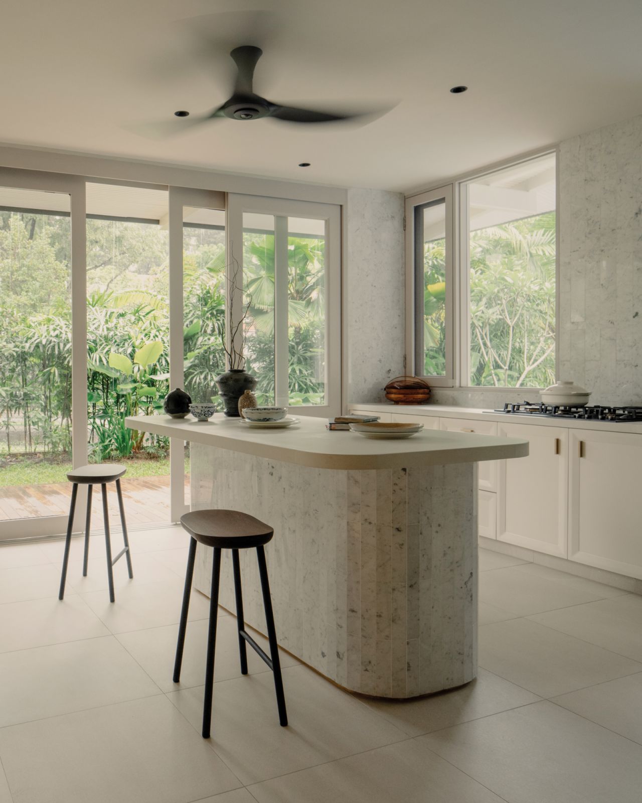 The kitchen exudes a sense of calm with its understated material palette and wealth of natural light