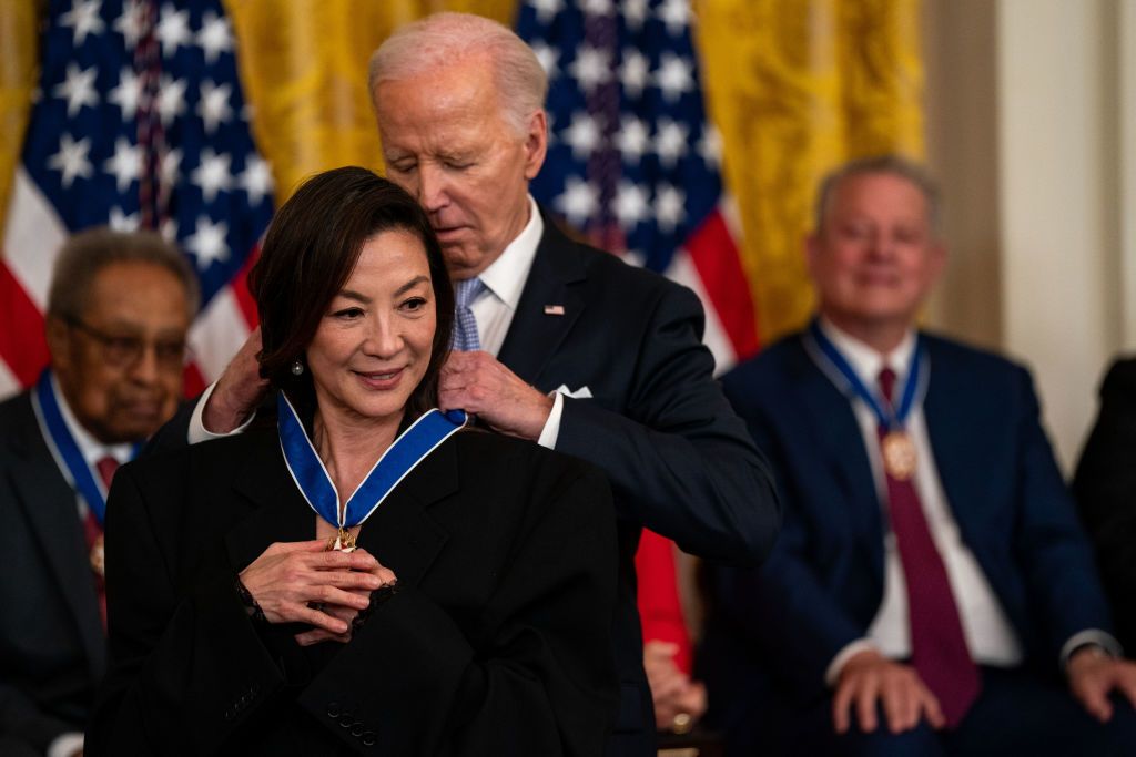WASHINGTON, DC - MAY 3: U.S. President Joe Biden presents the Presidential Medal of Freedom to actress Michelle Yeoh during a ceremony in the East Room of the White House on May 3, 2024 in Washington, DC. President Biden awarded the Presidential Medal of Freedom, the Nation's highest civilian honor, to 19 individuals including political leaders, civil rights icons and other influential cultural icons. (Photo by Kent Nishimura/Getty Images)