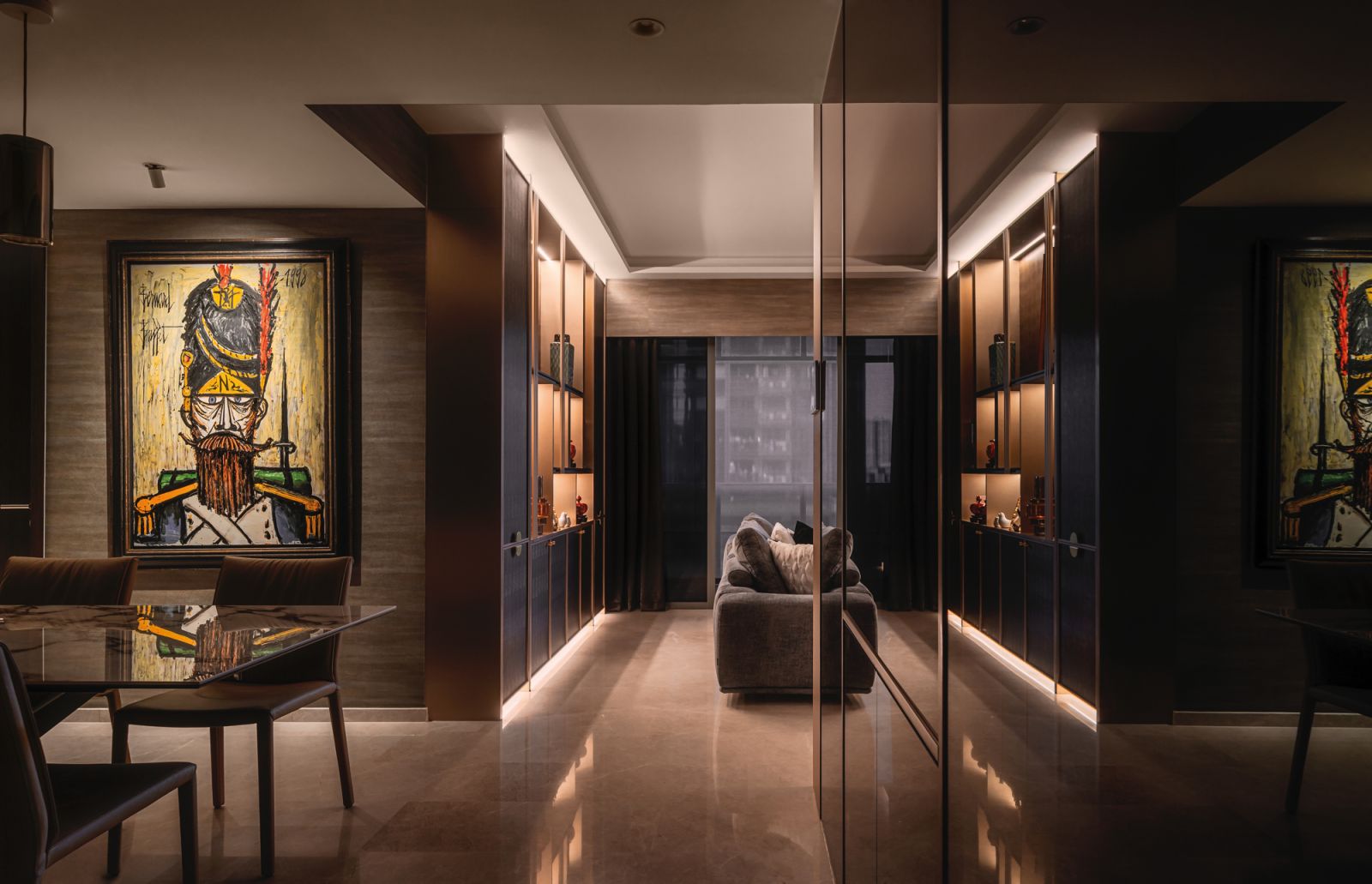 Artworks are placed throughout the apartment to add visual interest and an emotional element, as evidenced by the stern gaze of the rifleman pictured in this figurative piece by Bernard Buffet, which lords over the dining area