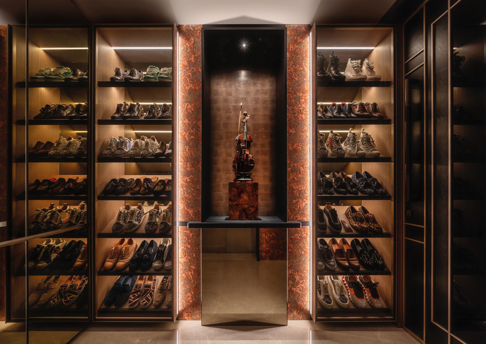 The husband’s beloved limited-edition sneakers are displayed alongside one of French artist Arman’s iconic violin sculptures