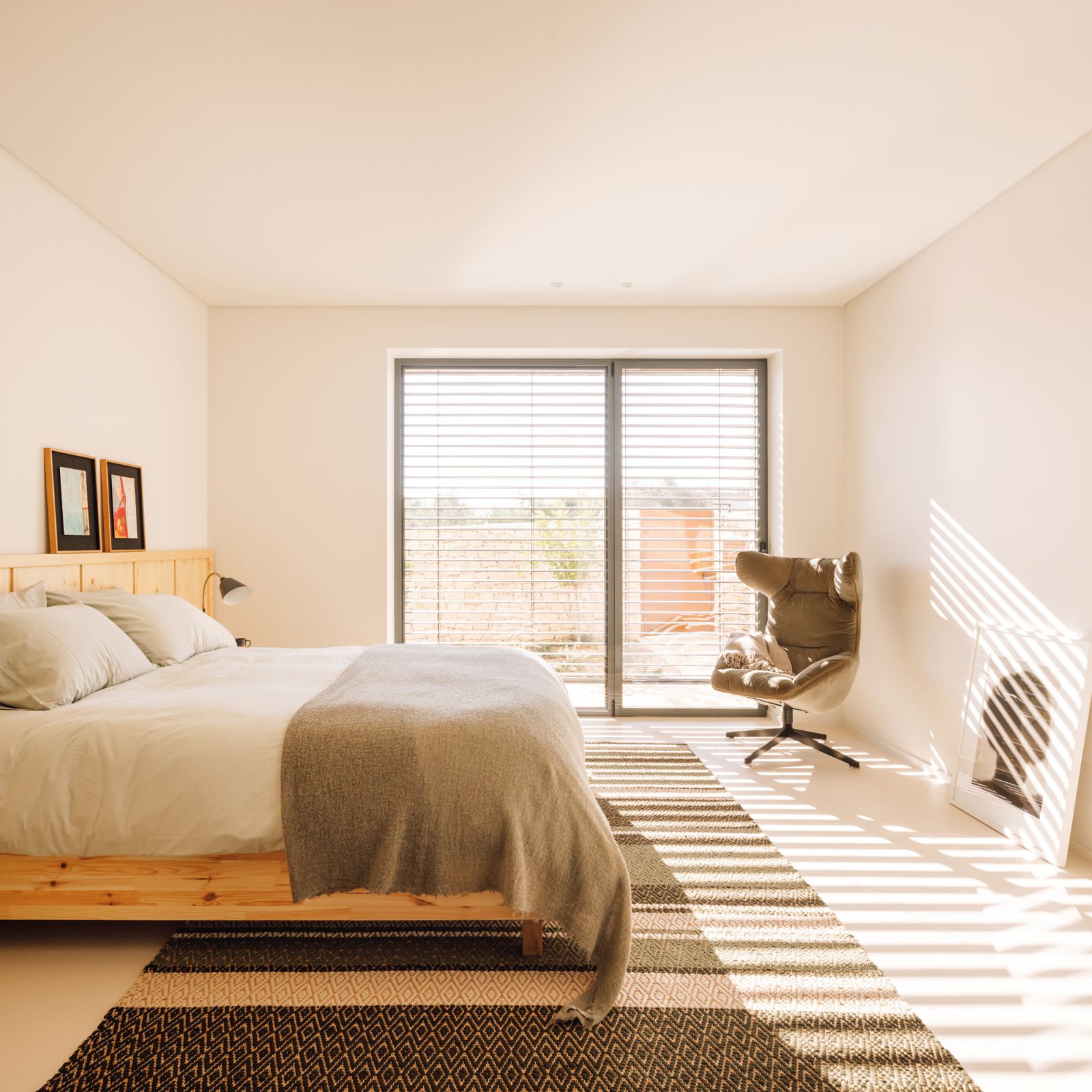 This light-infused bedroom sports a pastoral, earthy aesthetic with its pinewood headboard and handwoven cork rug