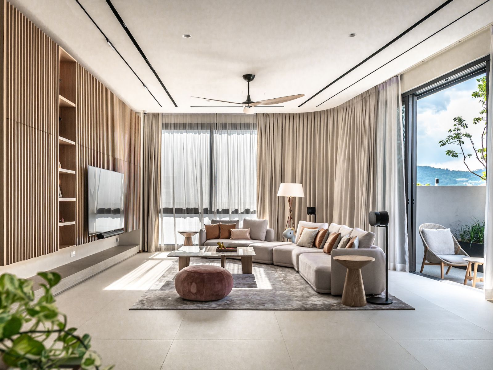 The interiors showcase a soft neutral palette with natural materials and light