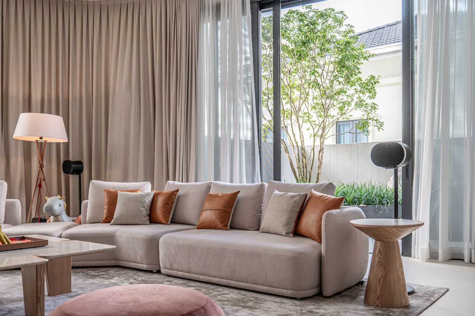 The interiors showcase a soft neutral palette with natural materials and light