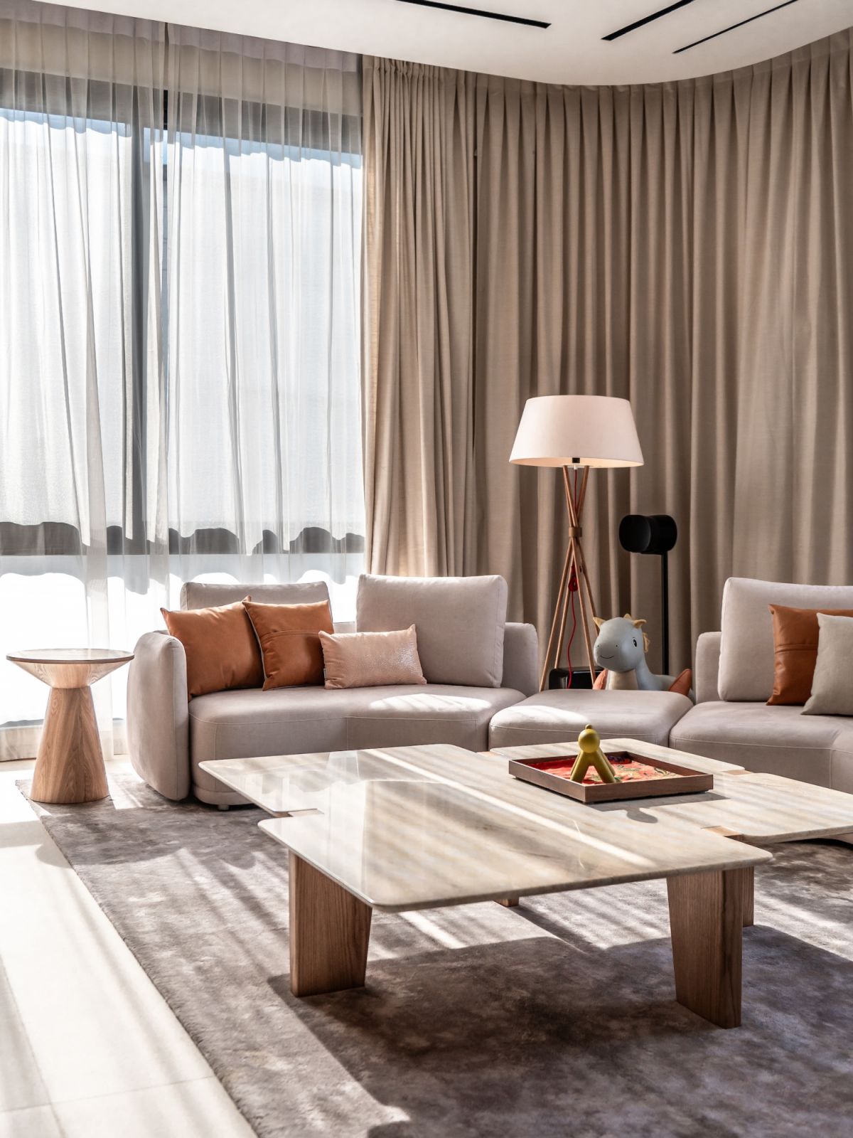 The interiors showcase a soft neutral palette with natural materials and light