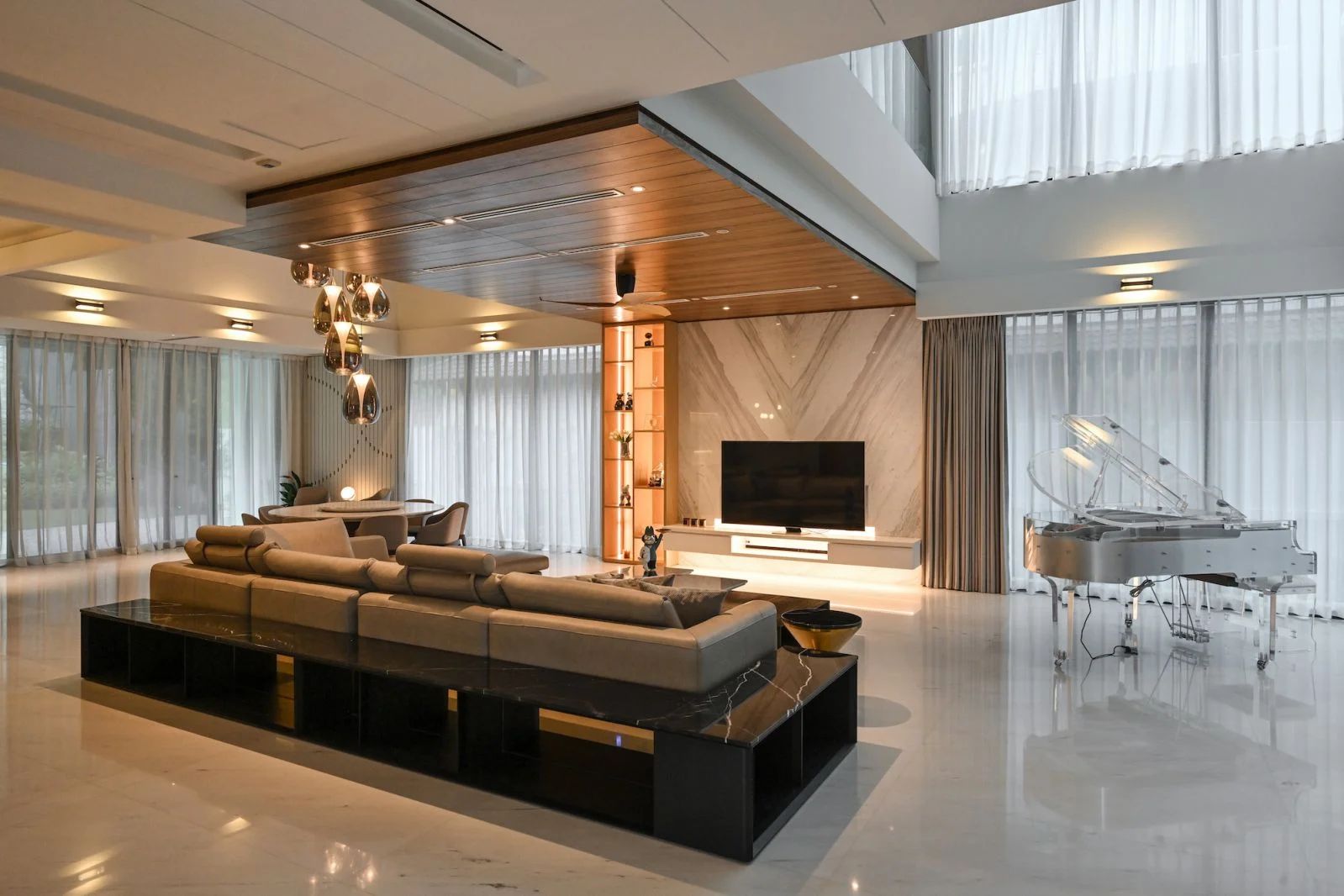 The double-volume void in the living room showcases a transparent grand piano (Photo: Gavin Yam)