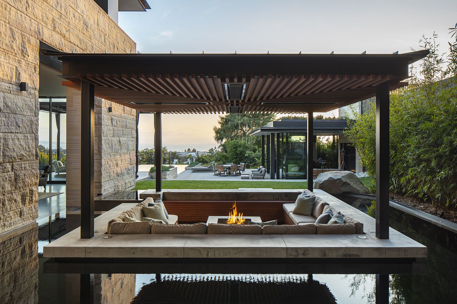 The outdoor seating area partially below the waterline of the koi pond