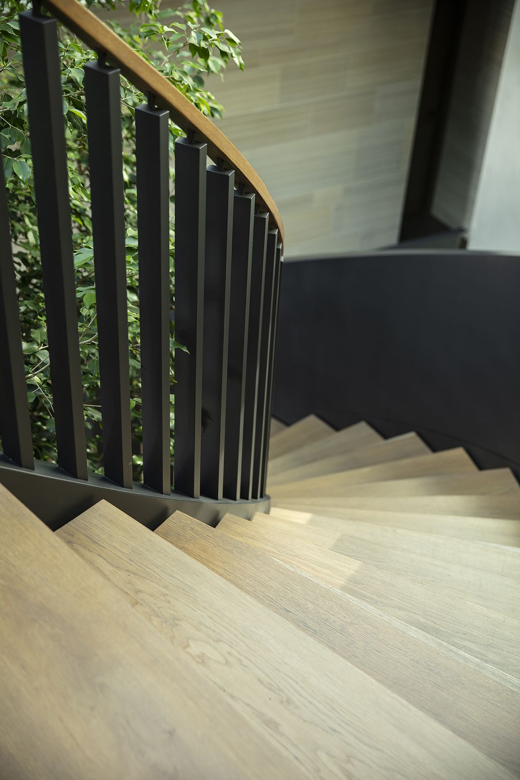 The dramatic curving steel staircase at connects the three levels