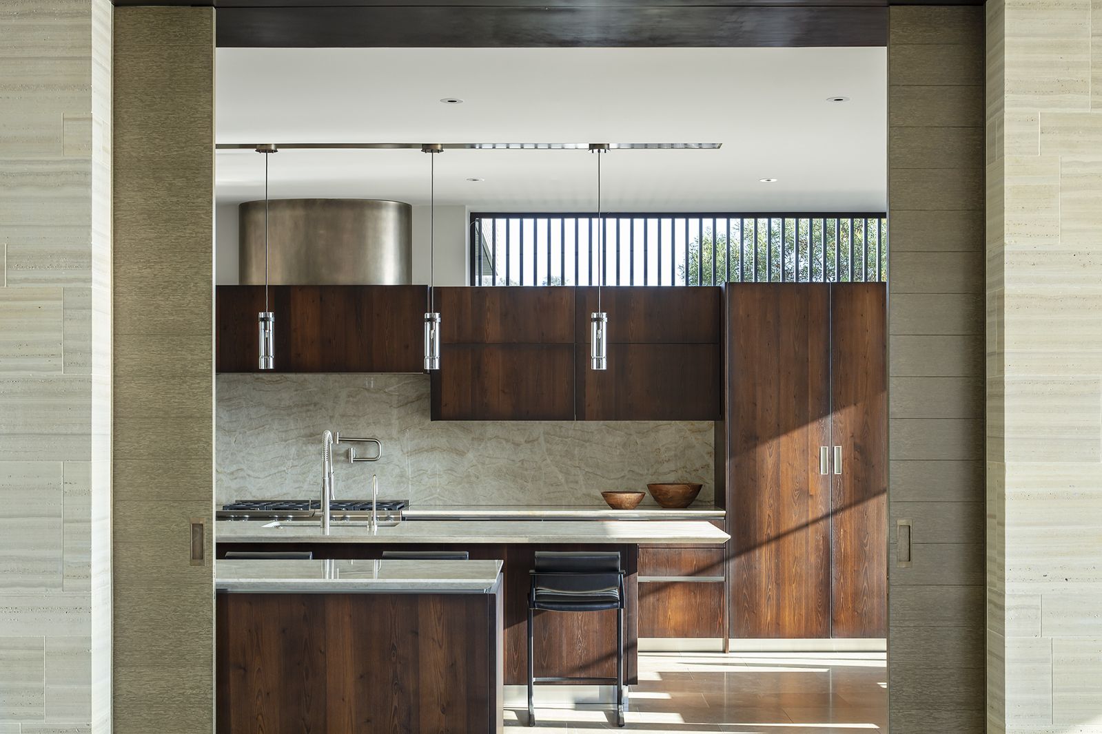 Brazilian quartzite counters and backsplash accented the dark-stained kitchen cabinets