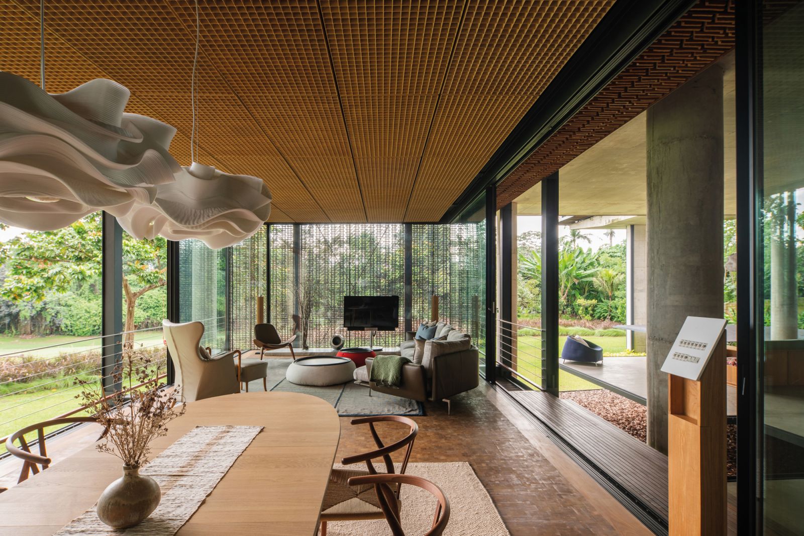 Woven rattan panels from Byo Living are used on the ceiling to bring a rustic warmth to the living-dining area