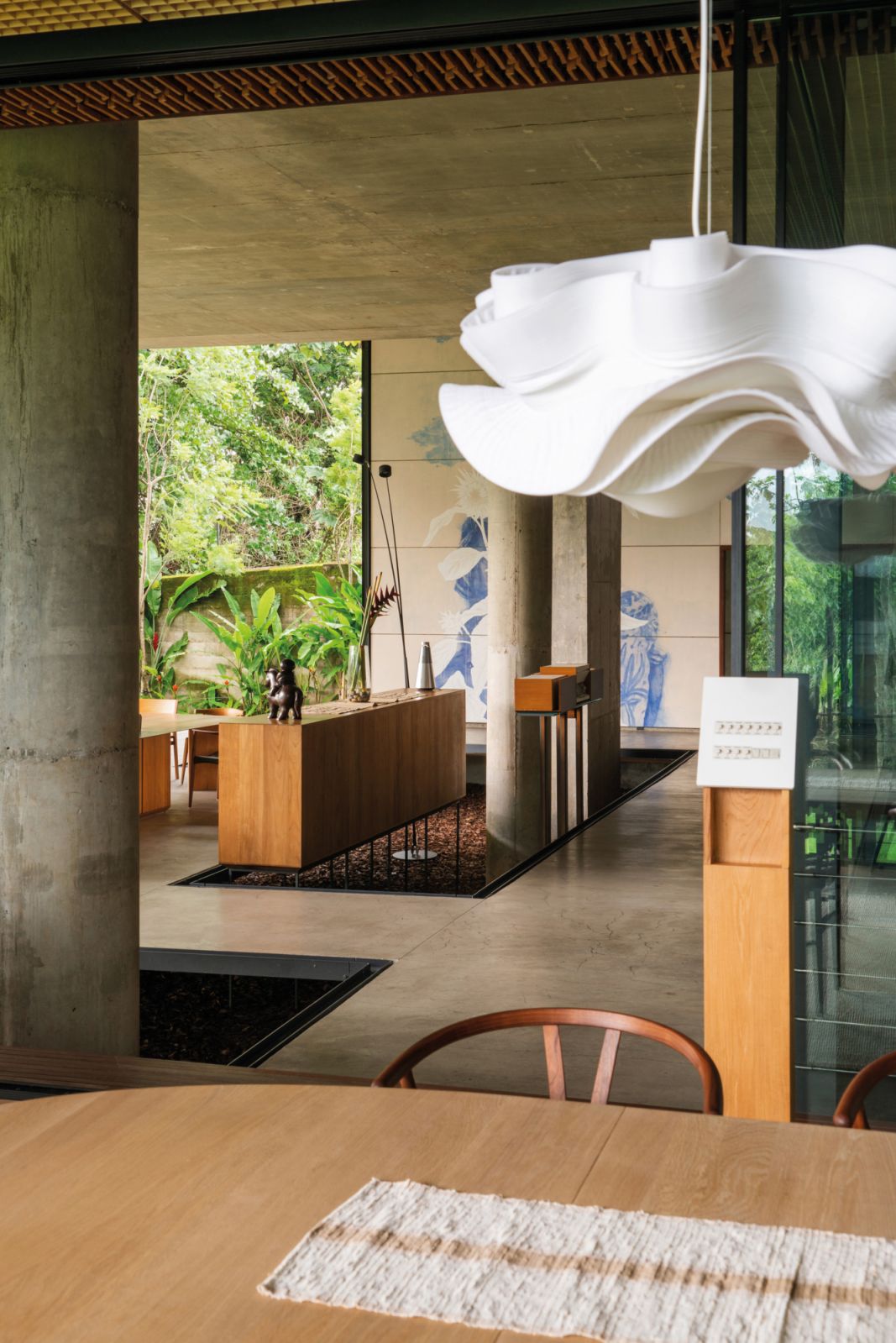 A pendant lamp from Ong Cen Kuang is matched with bespoke timber furniture from Eva Natasa