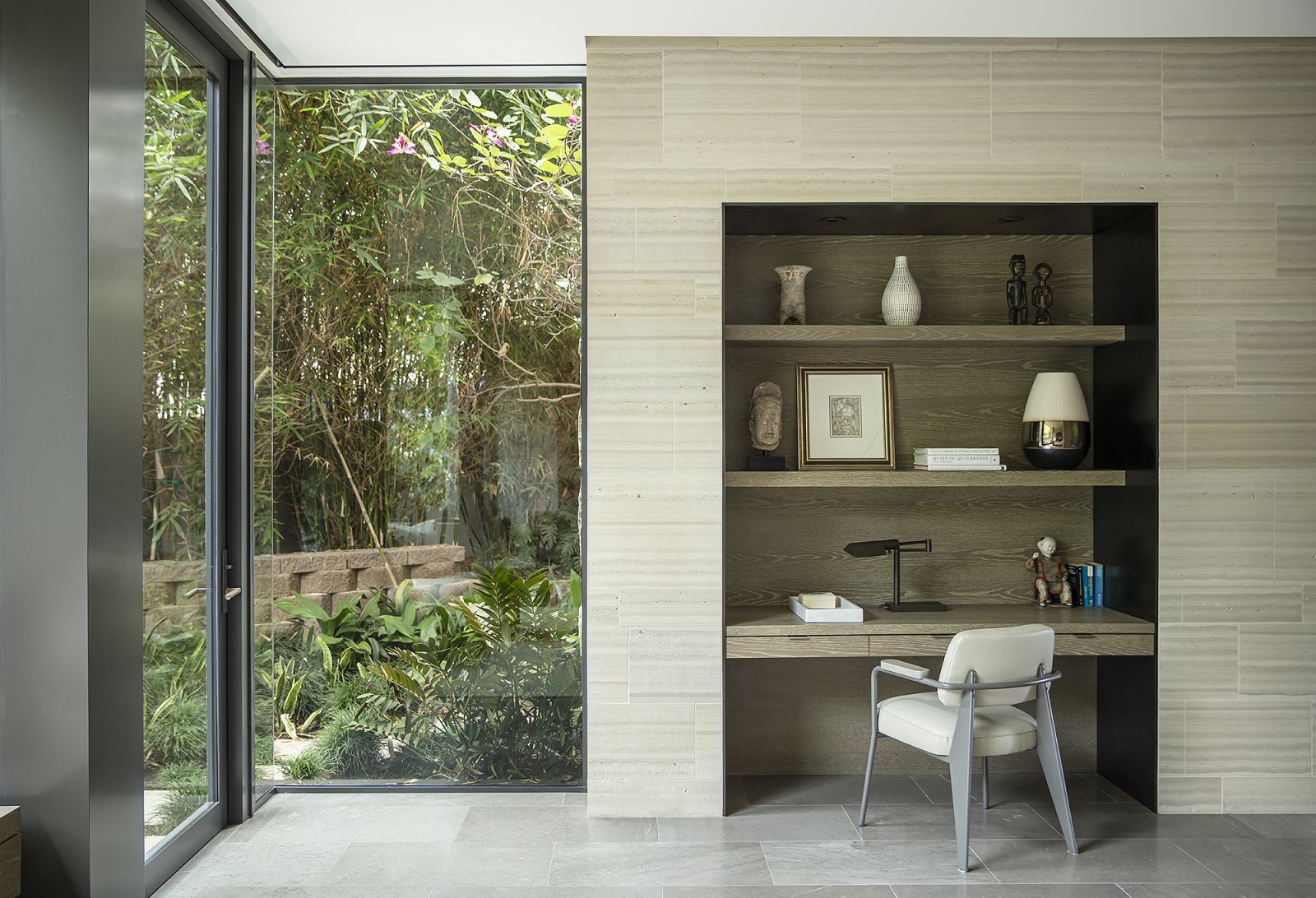 Honed limestone walls counterpoint the greenery outside