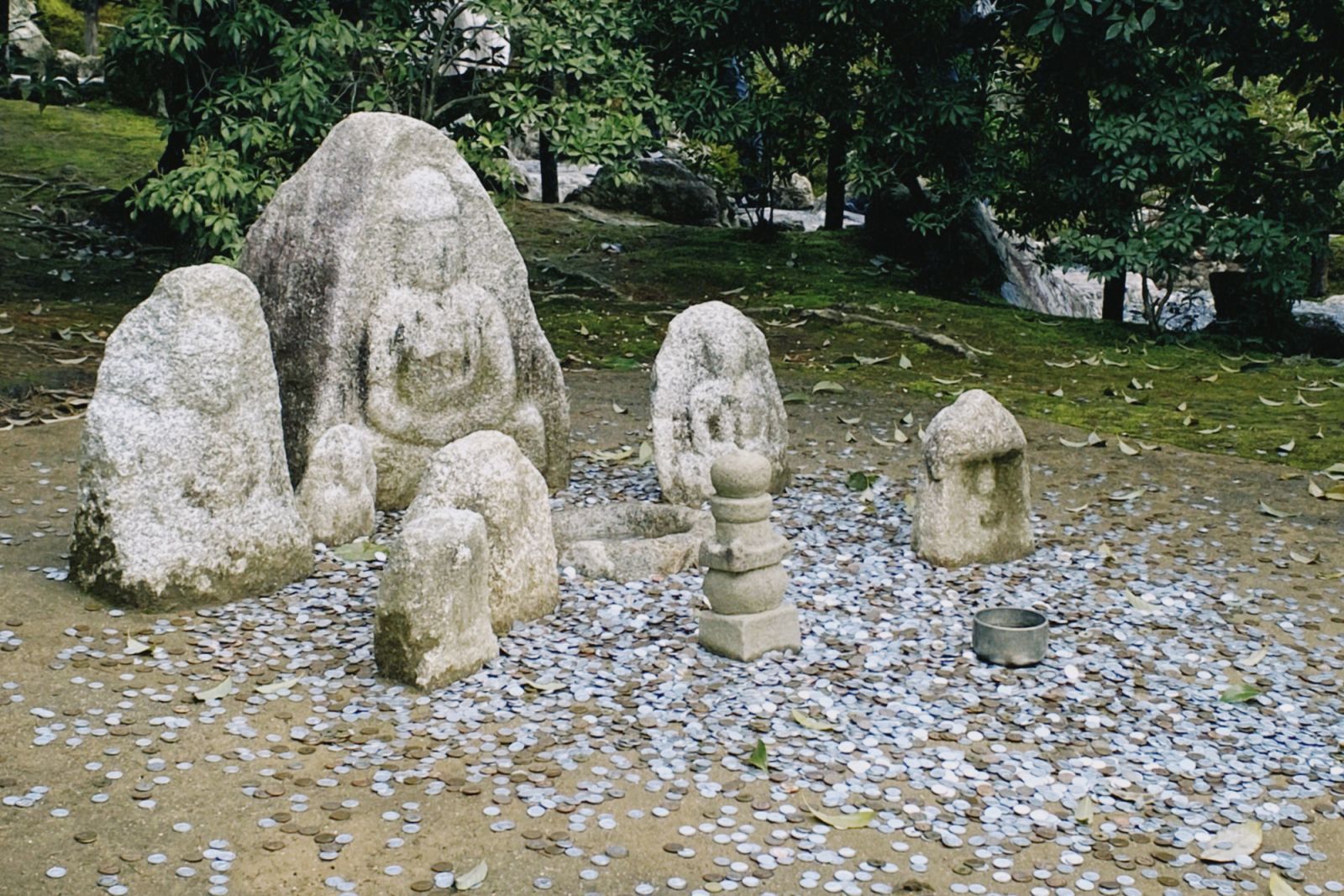 Coins offered to Buddha statues around the premises for luck