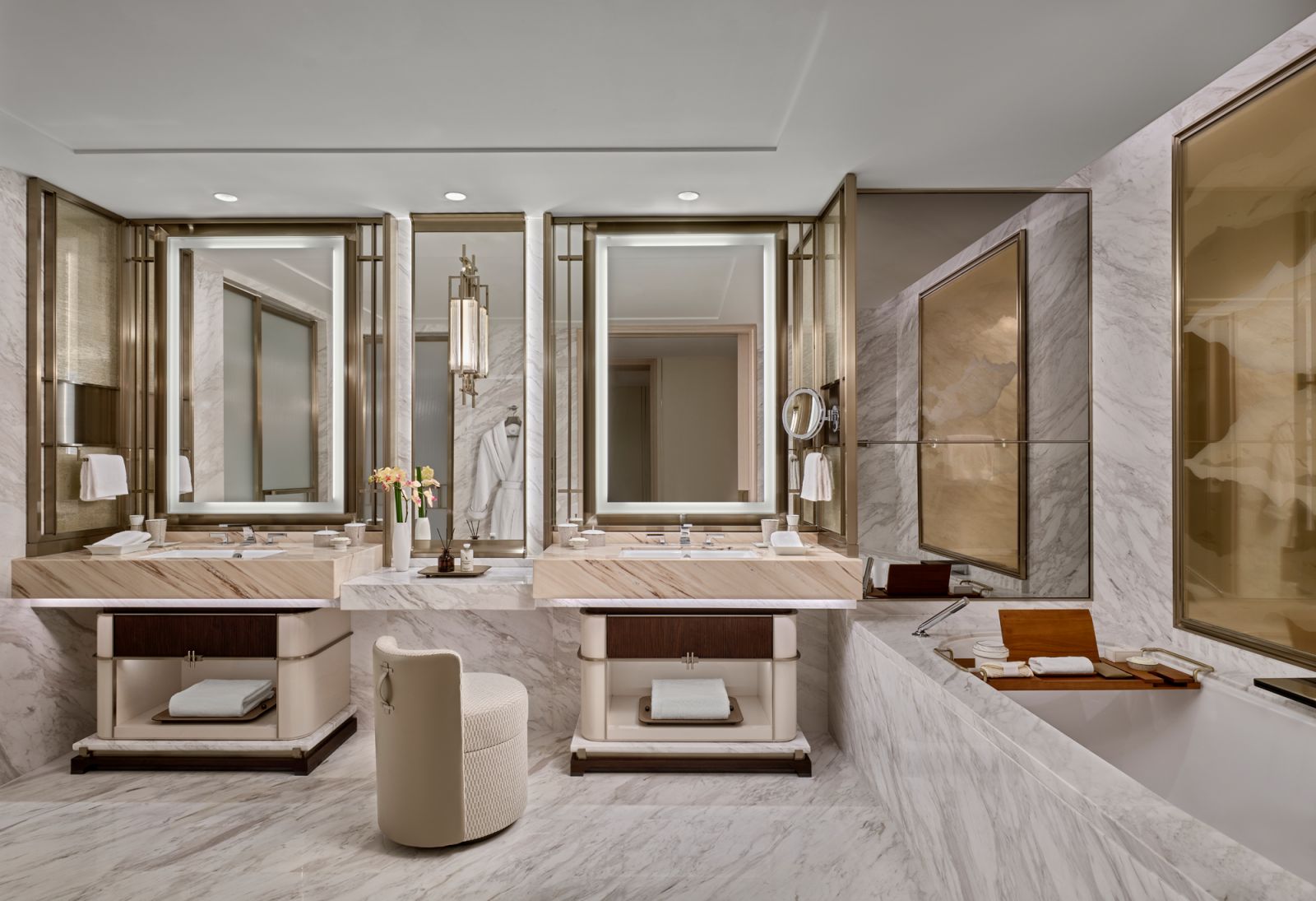 Freshen up at the double vanities clad with hand-selected marble