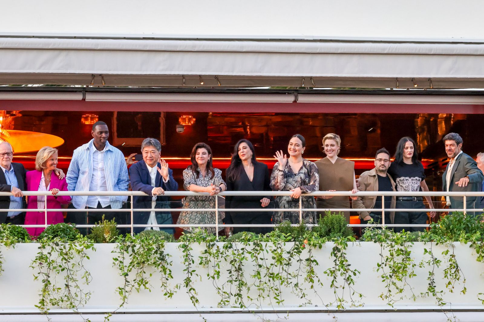 CANNES, FRANCE - MAY 13: (L-R) Thierry Fremaux, Iris Knobloch, Members of the Jury Omar Sy, Hirokazu Kore-Eda, Ebru Ceylan, Nadine Labaki, Lily Gladstone, President of the Jury Greta Gerwig, Juan Antonio Bayona, Eva Green and Pierfrancesco Favino attend a dinner ahead of the 77th Cannes Film Festival on May 13, 2024 in Cannes, France. (Photo by Marc Piasecki/GC Images)