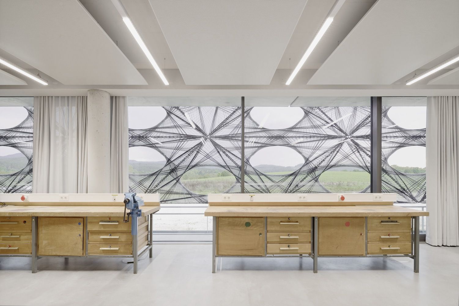 The industrial-style interior with glimpses outside through the exterior cutouts (Photo: Brigida González / Courtesy of allmannwappner)