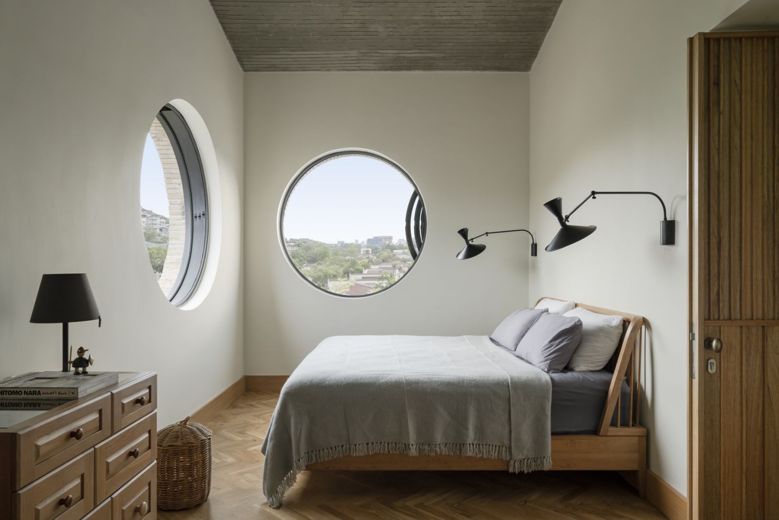 The master bedroom has charming round windows