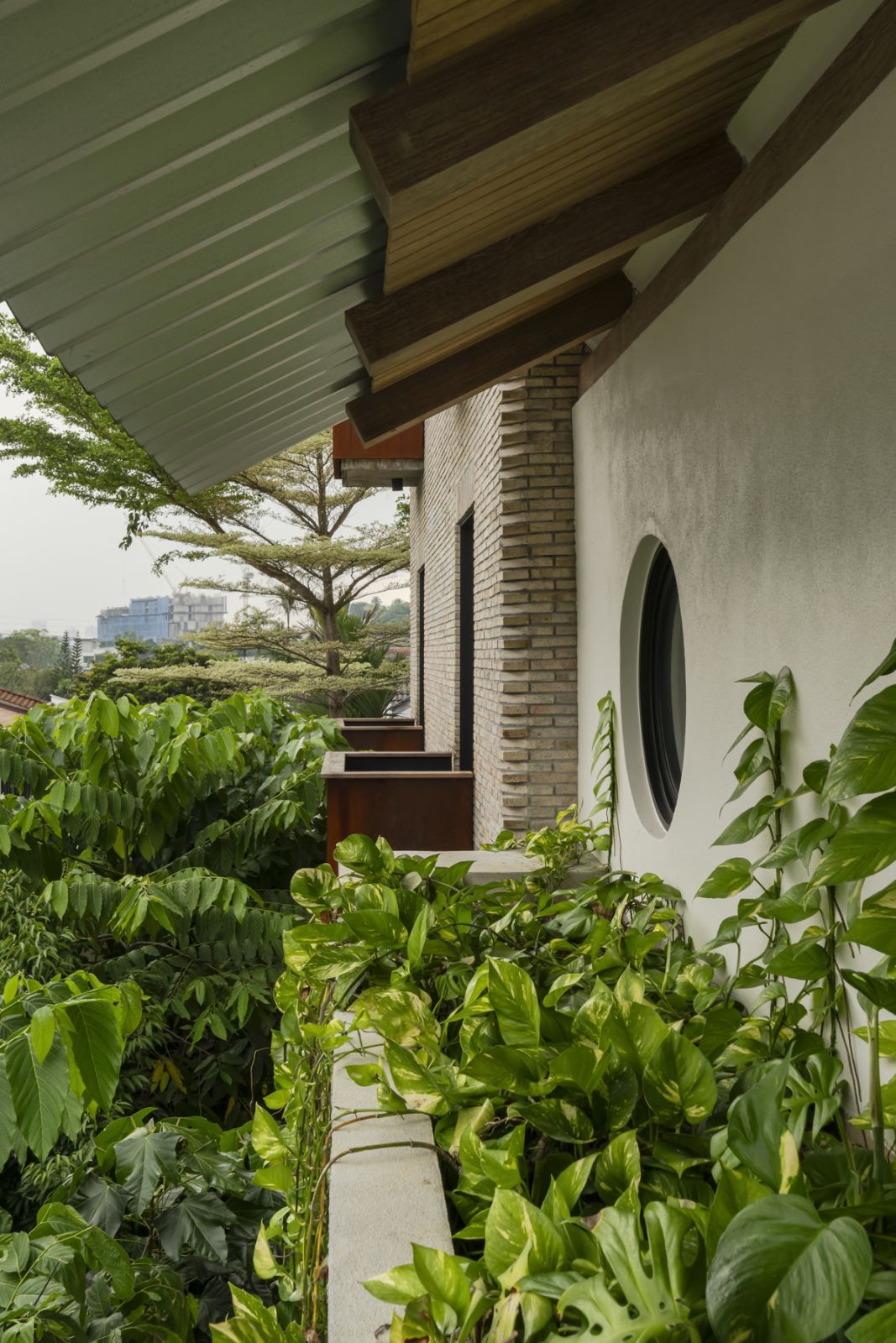 Lush greenery in planter boxes soften the hard surfaces