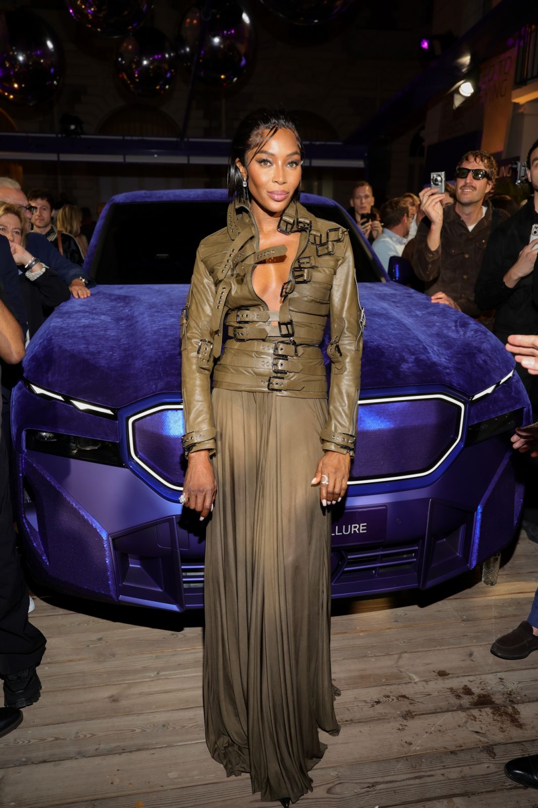 CANNES, FRANCE - MAY 15: Naomi Campbell poses next to the BMW XM Mystique Allure during the reveal event for the BMW XM inspired by Naomi Campbell at the House Of BMW on May 15, 2024 in Cannes, France. (Photo by Andreas Rentz/Getty Images for BMW)