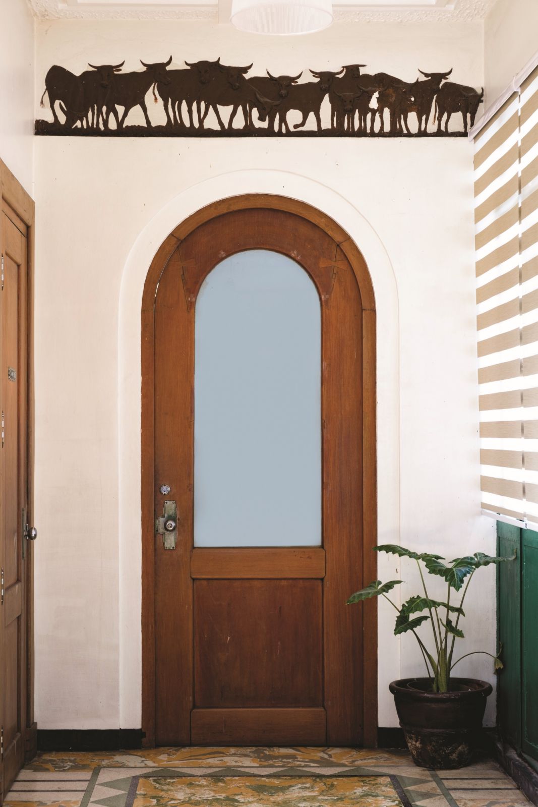 A herd of carabaos design above the arched door on the third floor