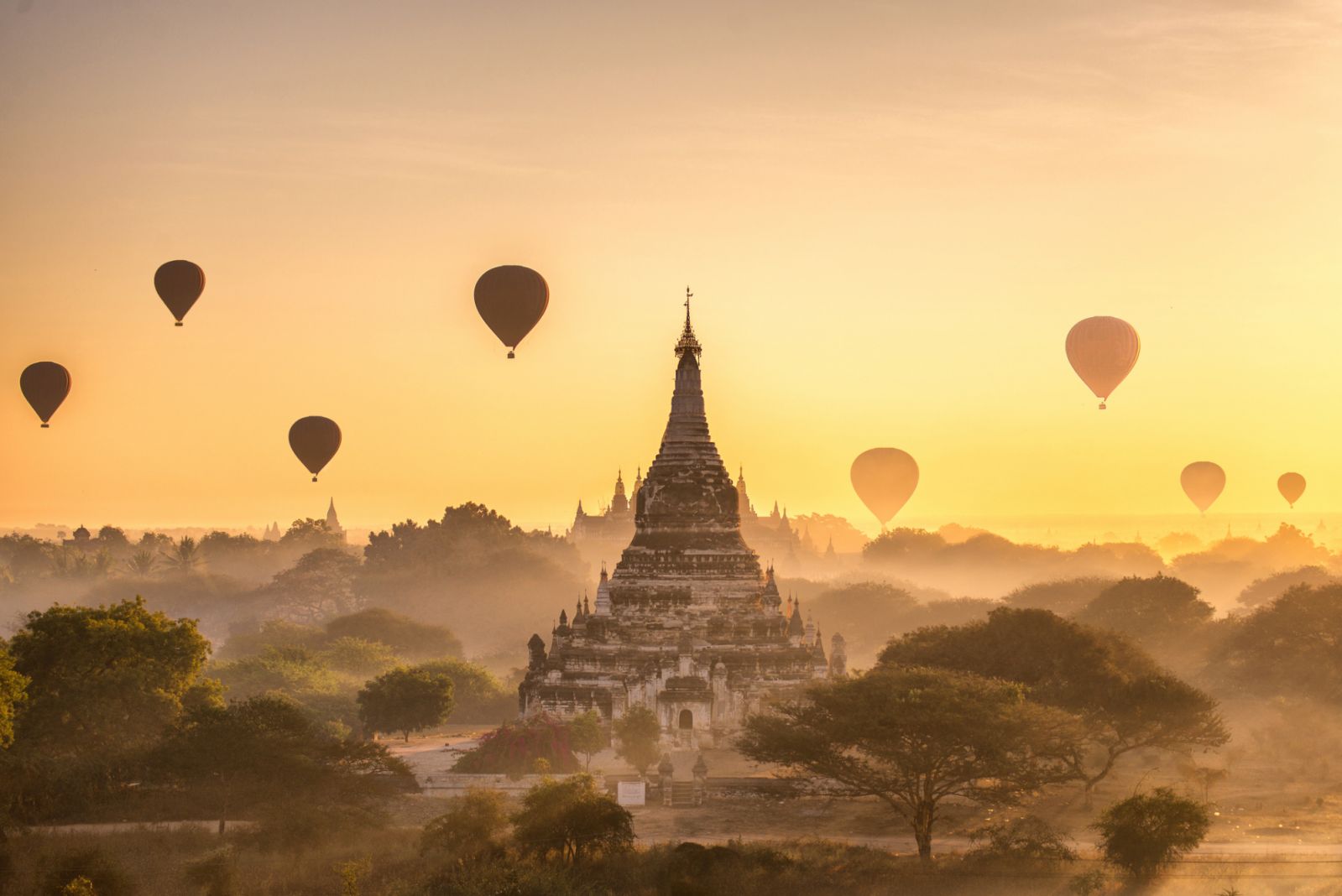 tourist hot air balloon over Ancient Pagoda at Bagan in Myanmar, tourists watching sunrise over ancient city
