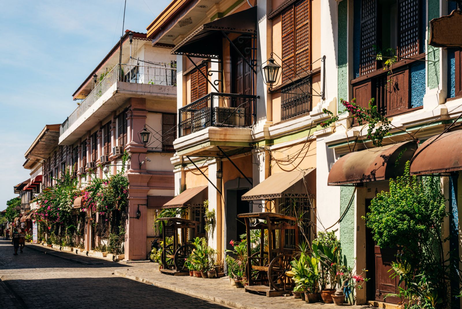 A wooden bench made from an old wagon stock Antique wood furniture along cobblestone sidewalk in Vigan City, Ilocos Sur, Philippines