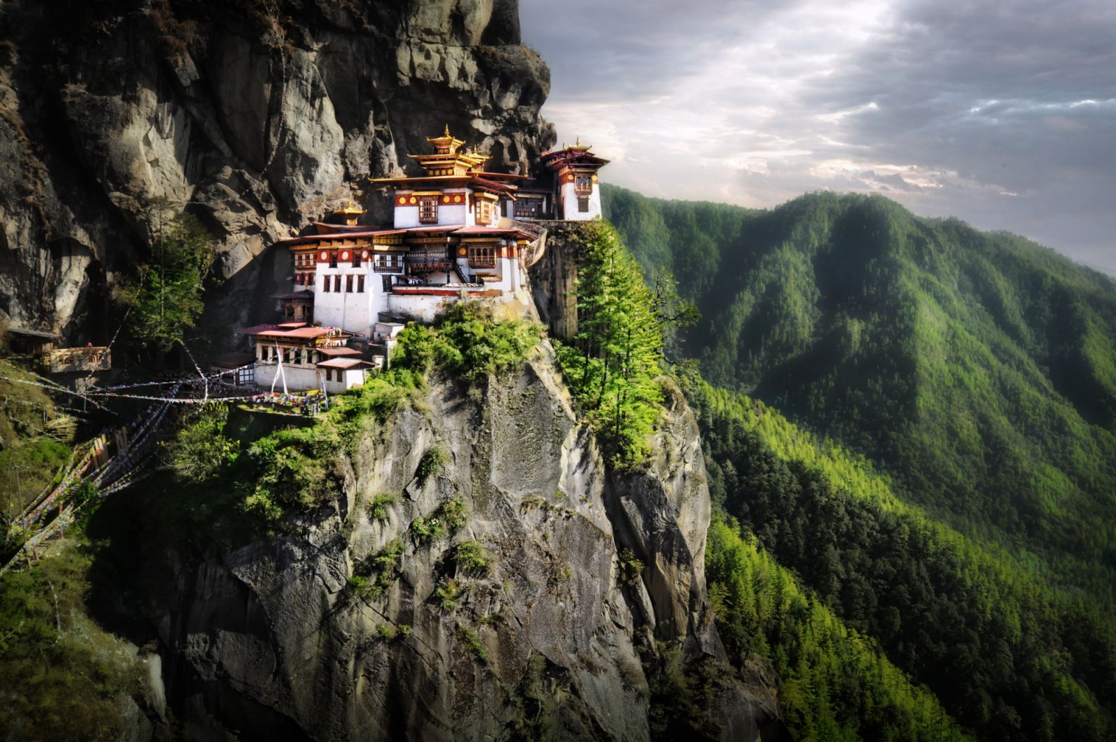 Himalayan Mountains sits Tiger Nest Monastery. Located near city of Paro in Kingdom of Bhutan.