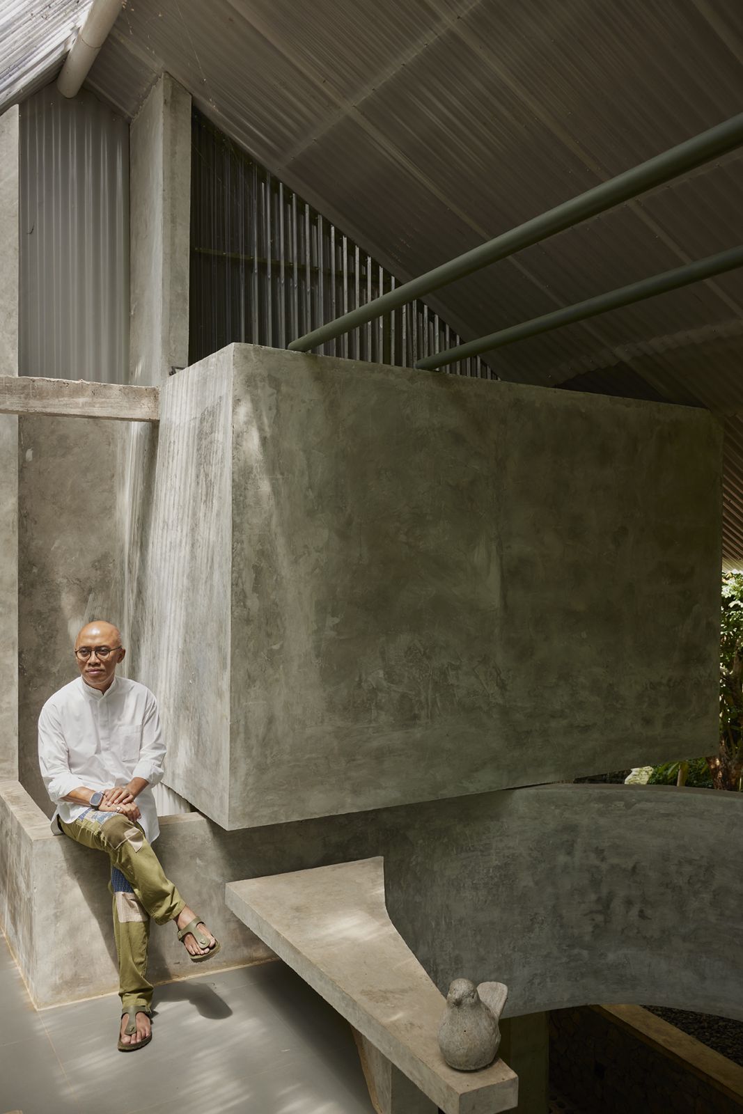 Indonesian architect Ary Indrajanto at his two-storey concrete studio in Selojene complex, Salatiga, Indonesia