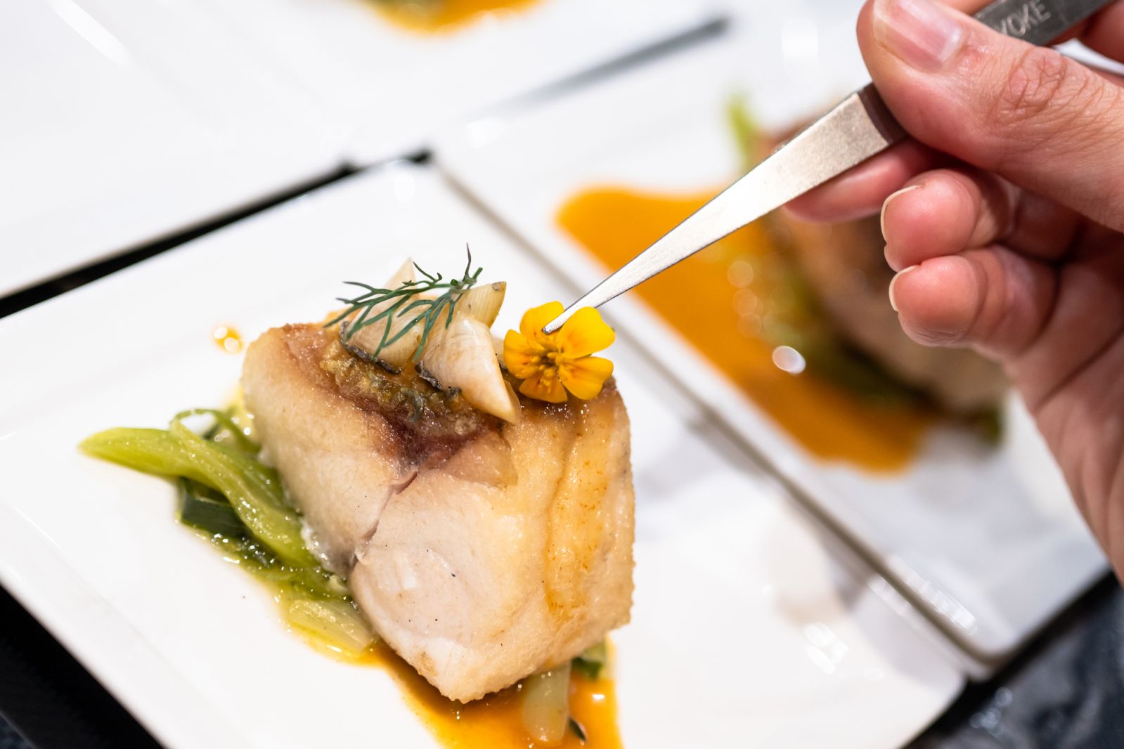 Assembling the seabass, complete with crispy scales