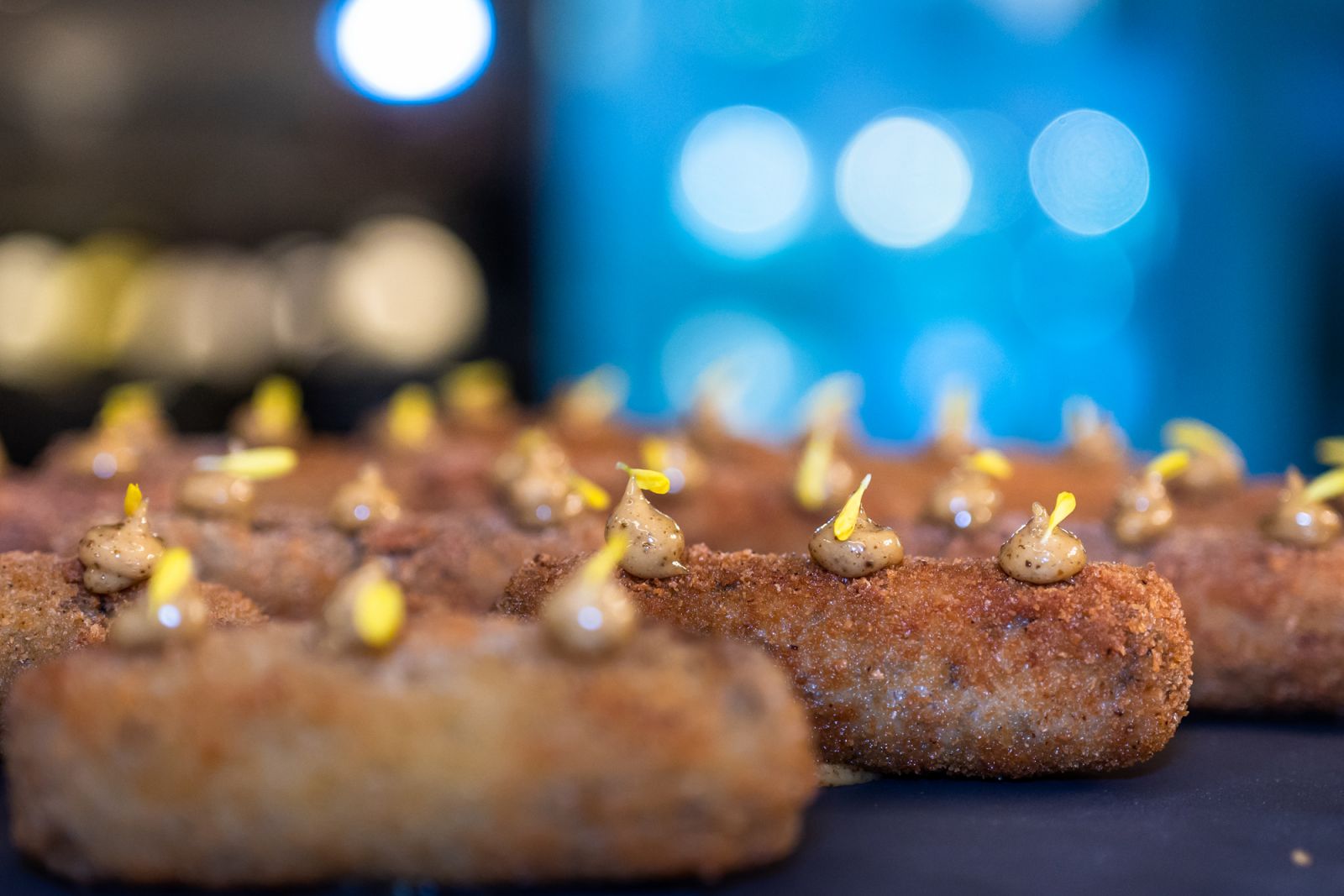 A close-up of the arancini with black olive