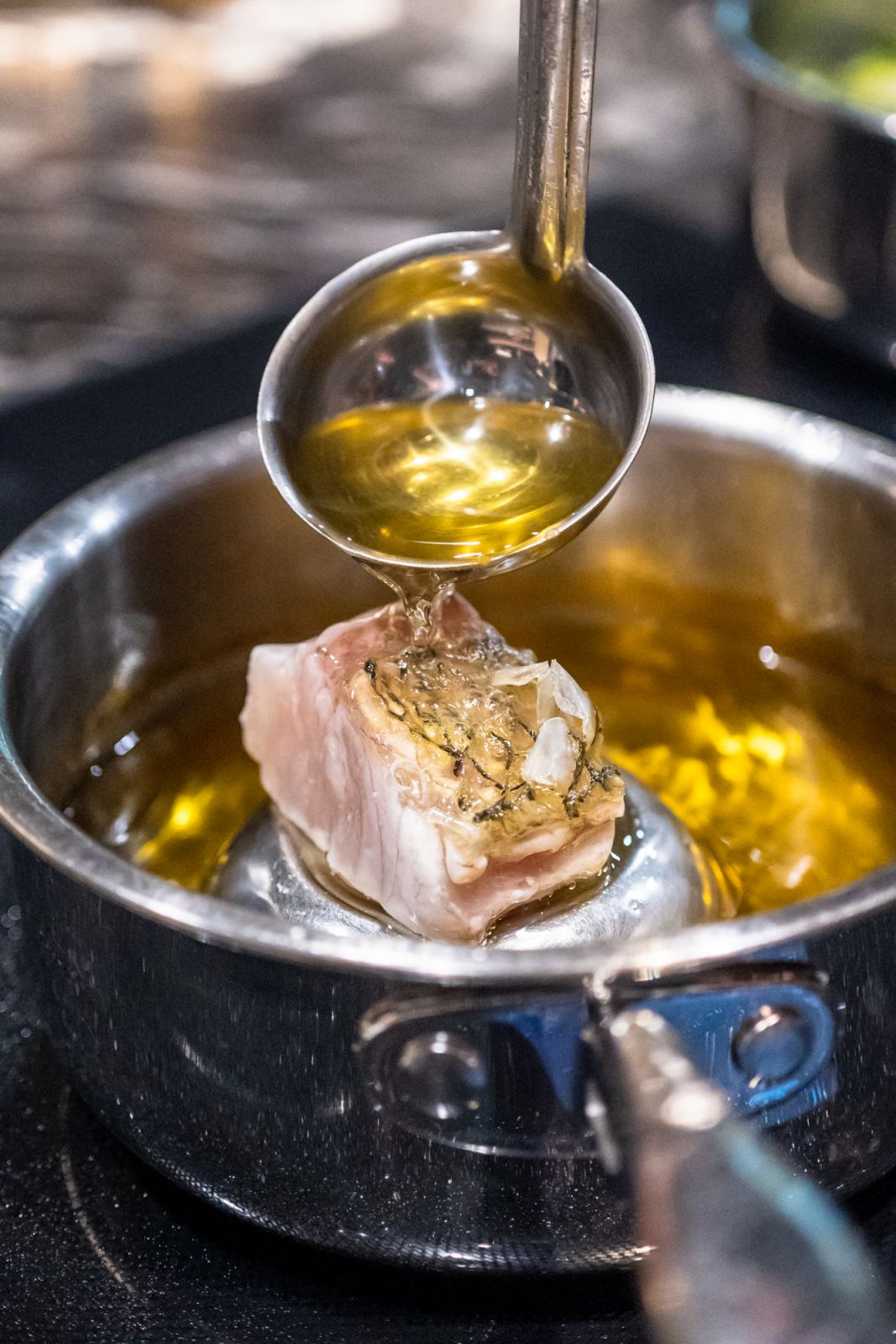 The zero-waste seabass cooking in hot oil complete with crispy scales