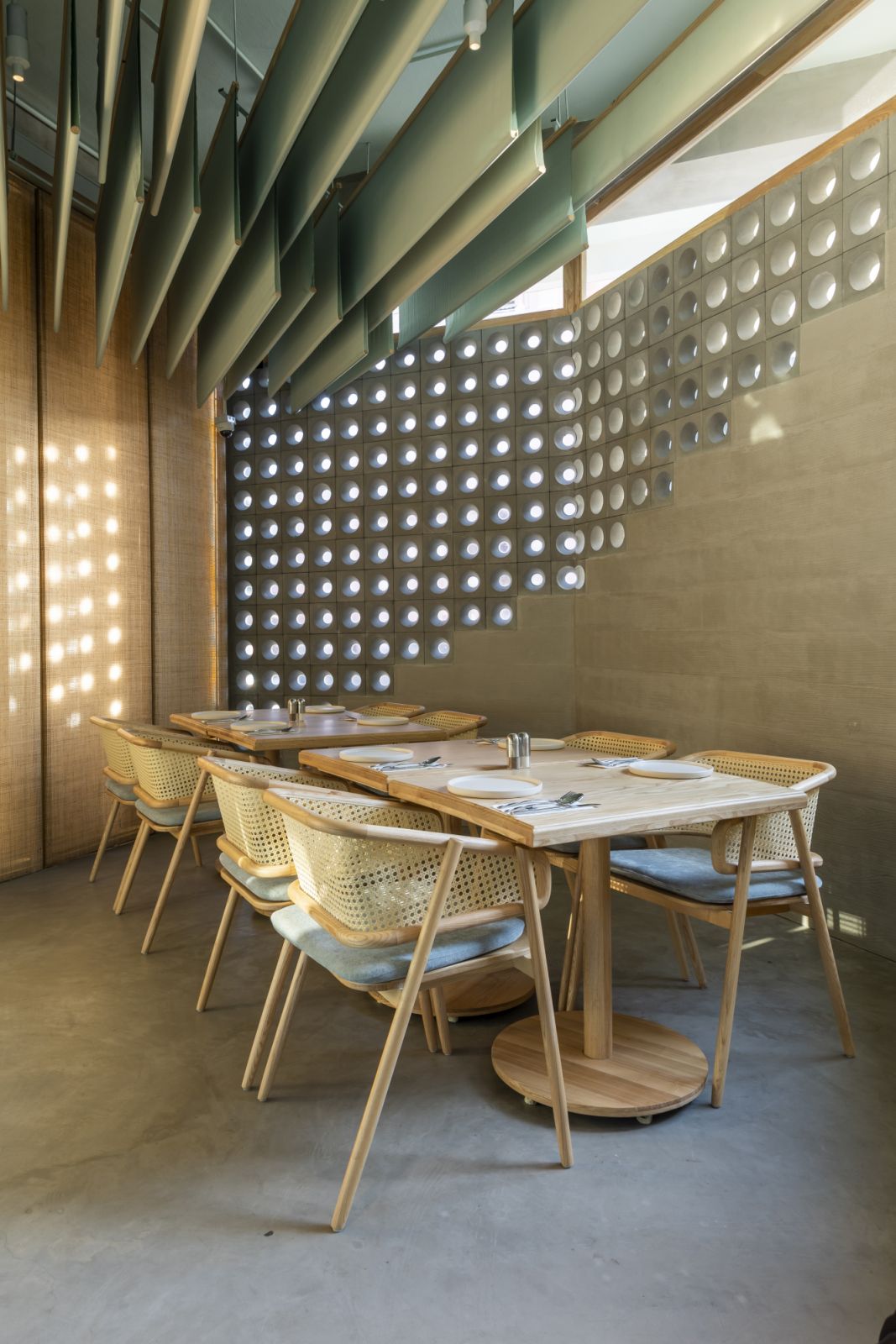 Corner table setting on 1st floor café beside the boundary breeze blocks wall looking out into Tan Dinh Church