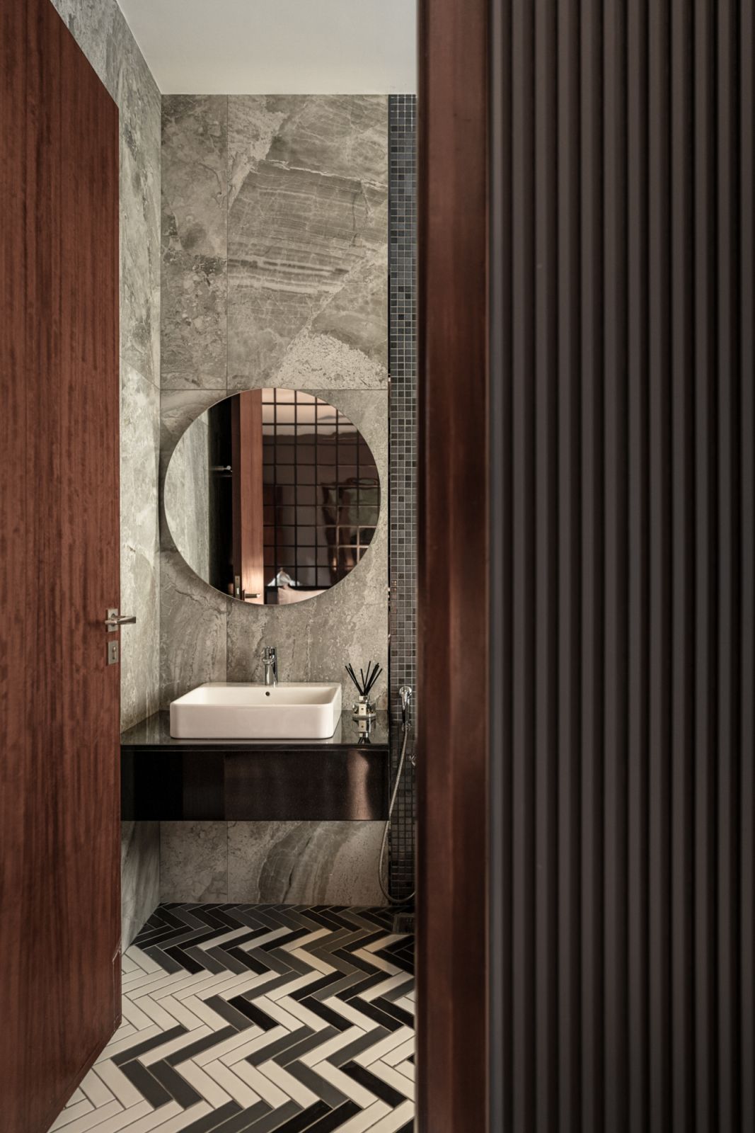 The bathroom is a deft juxtaposition of contrasting materials