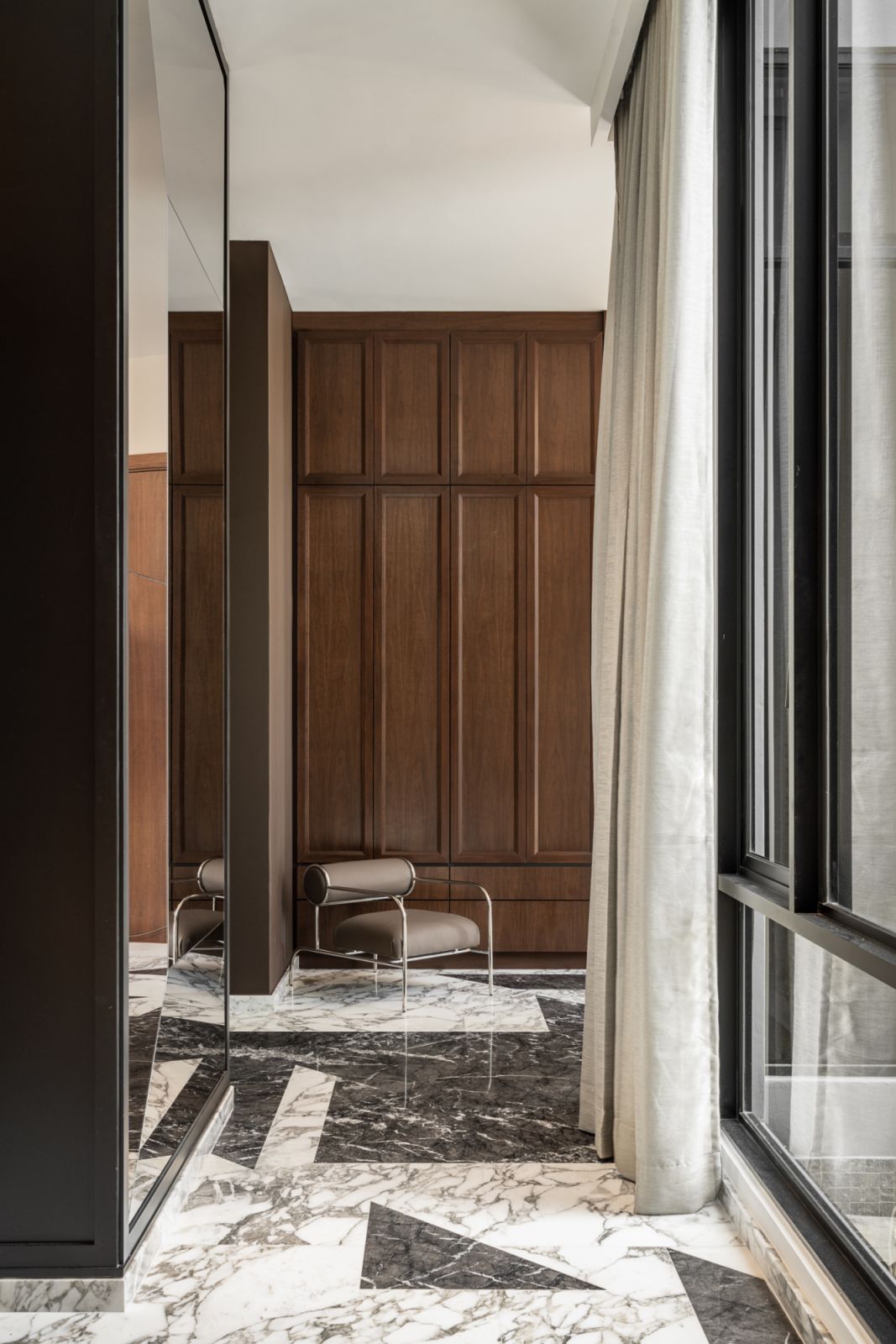Dark wood and marble pair well in the foyer