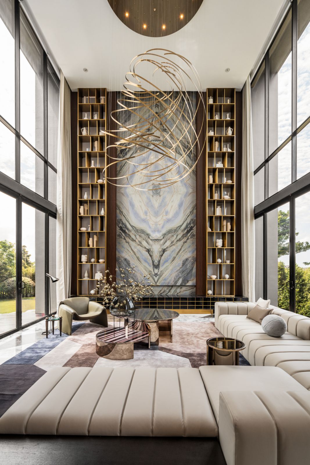 The glamorous living room has many wow pieces including the impressive modern chandelier