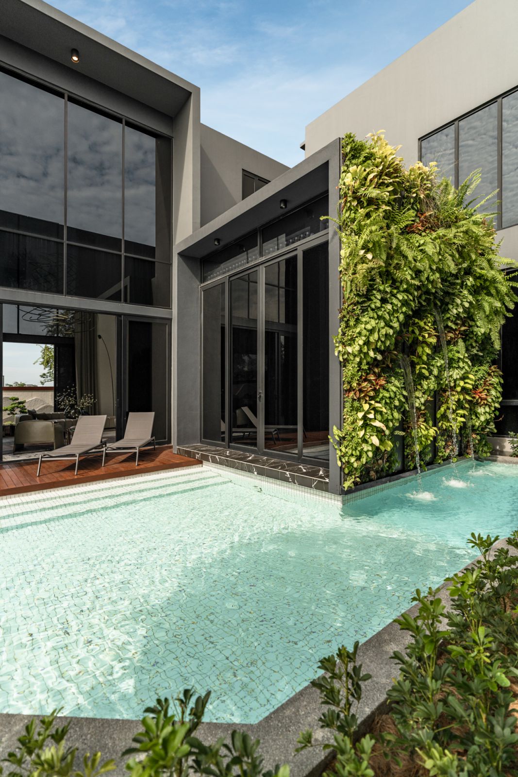 Lush greenery softens the glass and concrete