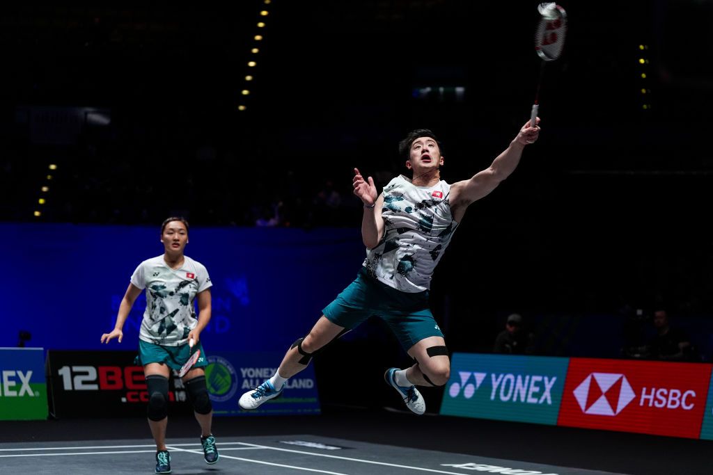 BIRMINGHAM, ENGLAND - MARCH 15: Tang Chun Man (R) and Tse Ying Suet of Hong Kong compete in the Mixed Doubles Quarter Finals match against Feng Yanzhe and Huang Dongping of China during day four of the Yonex All England Open Badminton Championships 2024 at Utilita Arena Birmingham on March 15, 2024 in Birmingham, England. (Photo by Shi Tang/Getty Images)