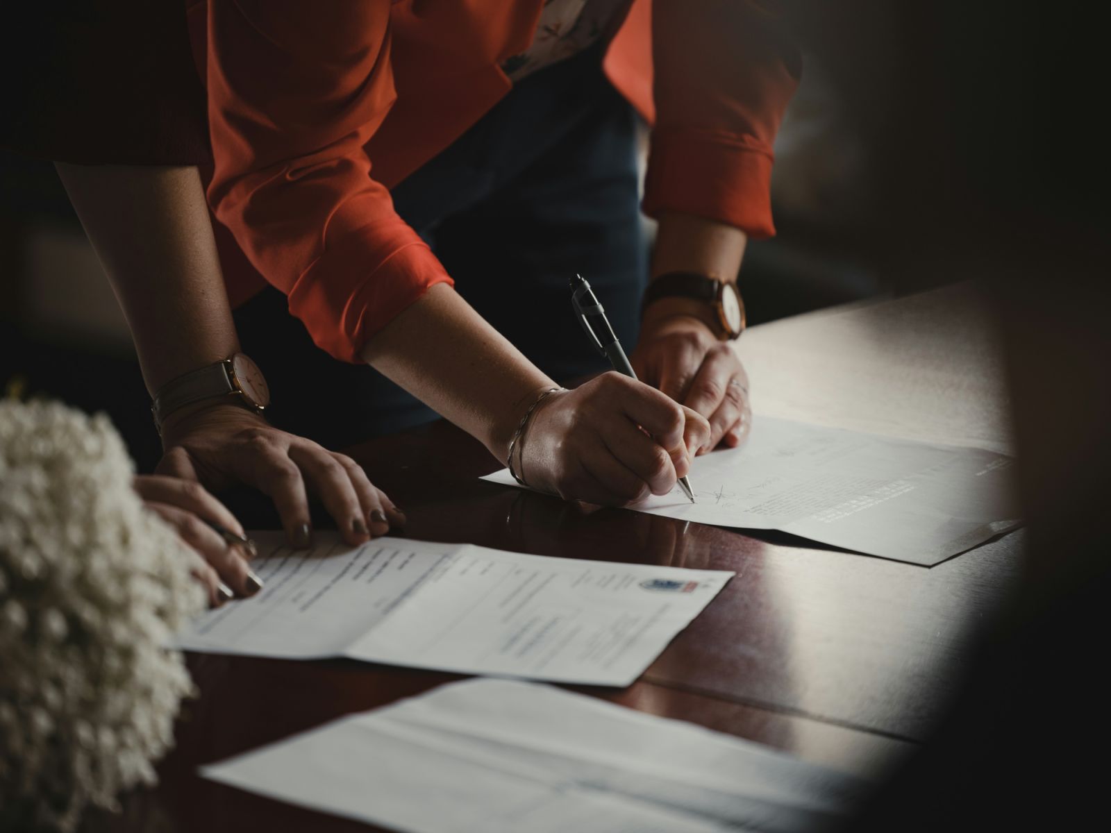 Couple signing documents (Photo: Romain Dancre/Unsplash)