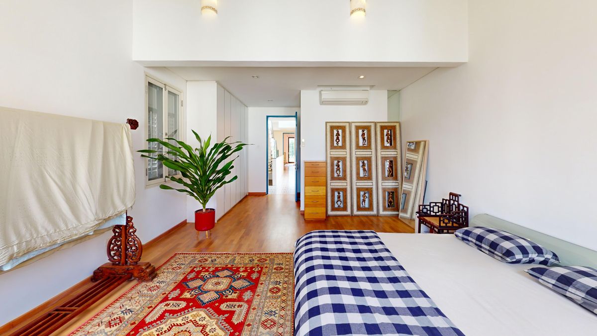 The master bedroom's furnishing includes a variety of modern and antique pieces, reflective of the owner's design inspirations